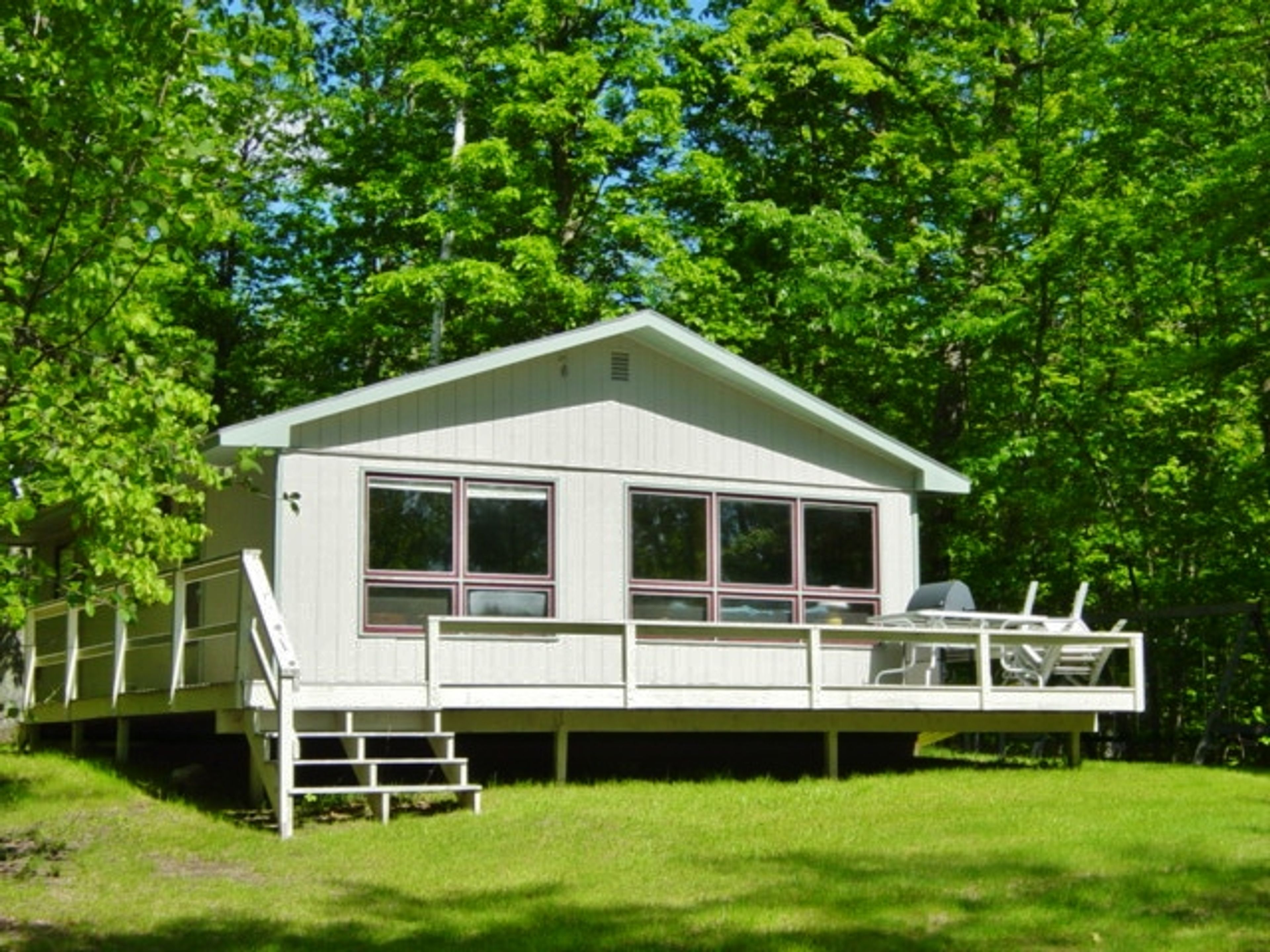 Cabin Exterior | Furnished Wraparound Deck | Gas Grill