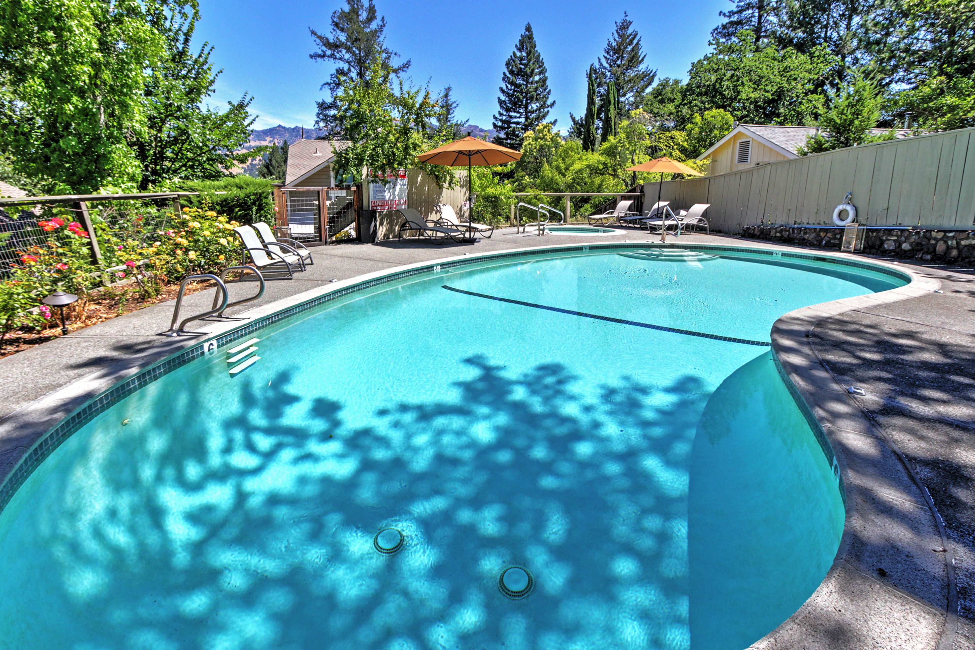 The picturesque exterior space features a private pool, hot tub and courtyard.