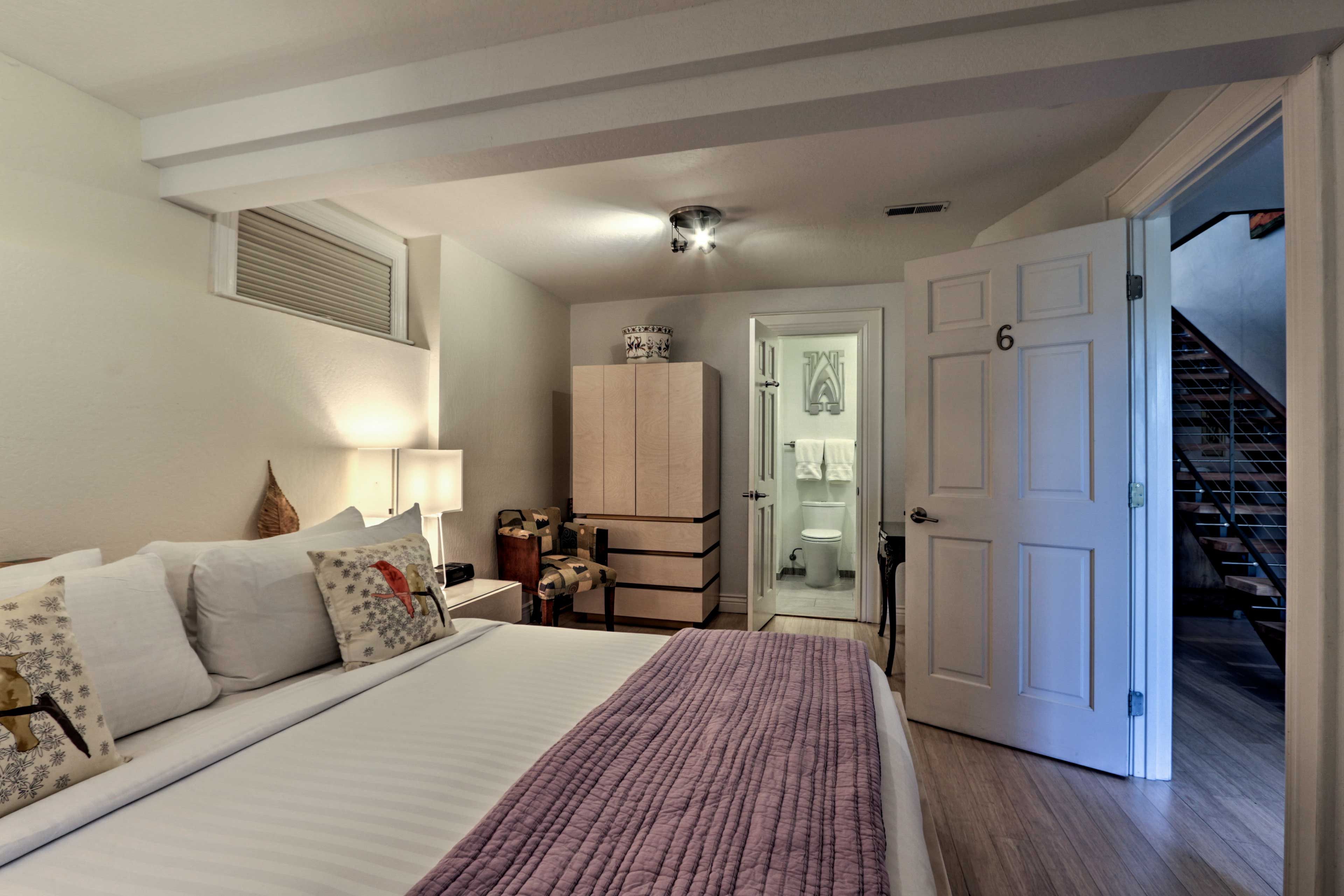 This lower-level bedroom features an en-suite bathroom.