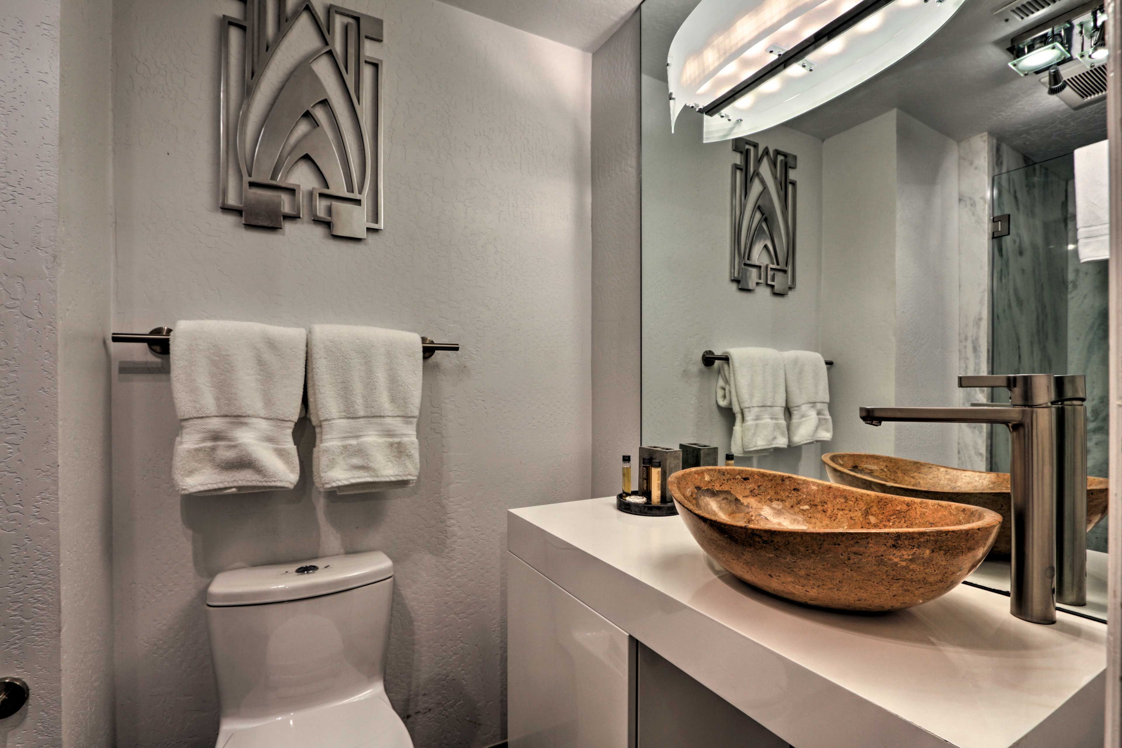 The en-suite bath boasts a stylish bowl sink and walk-in shower.