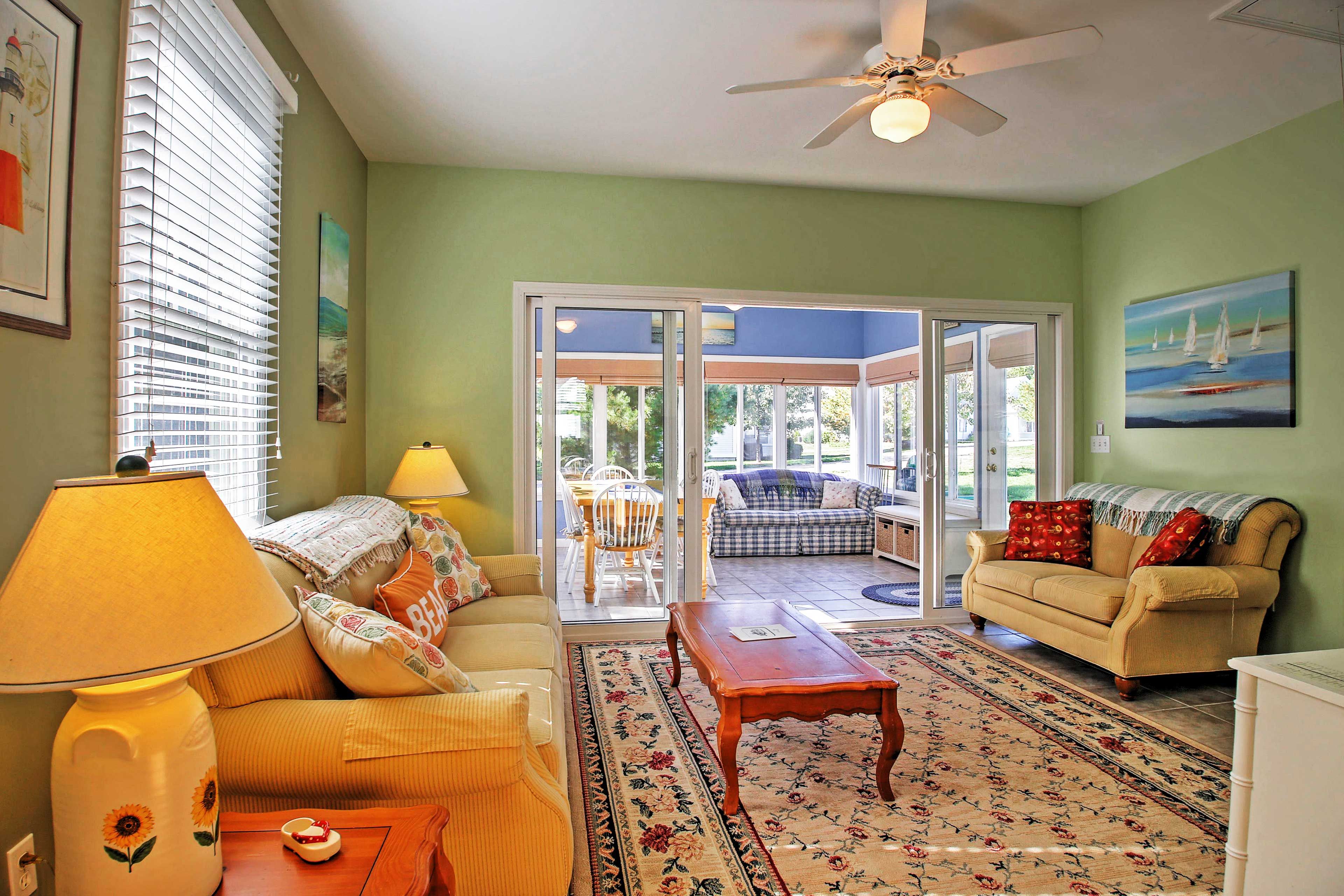 The living room expands into the spacious sun room.