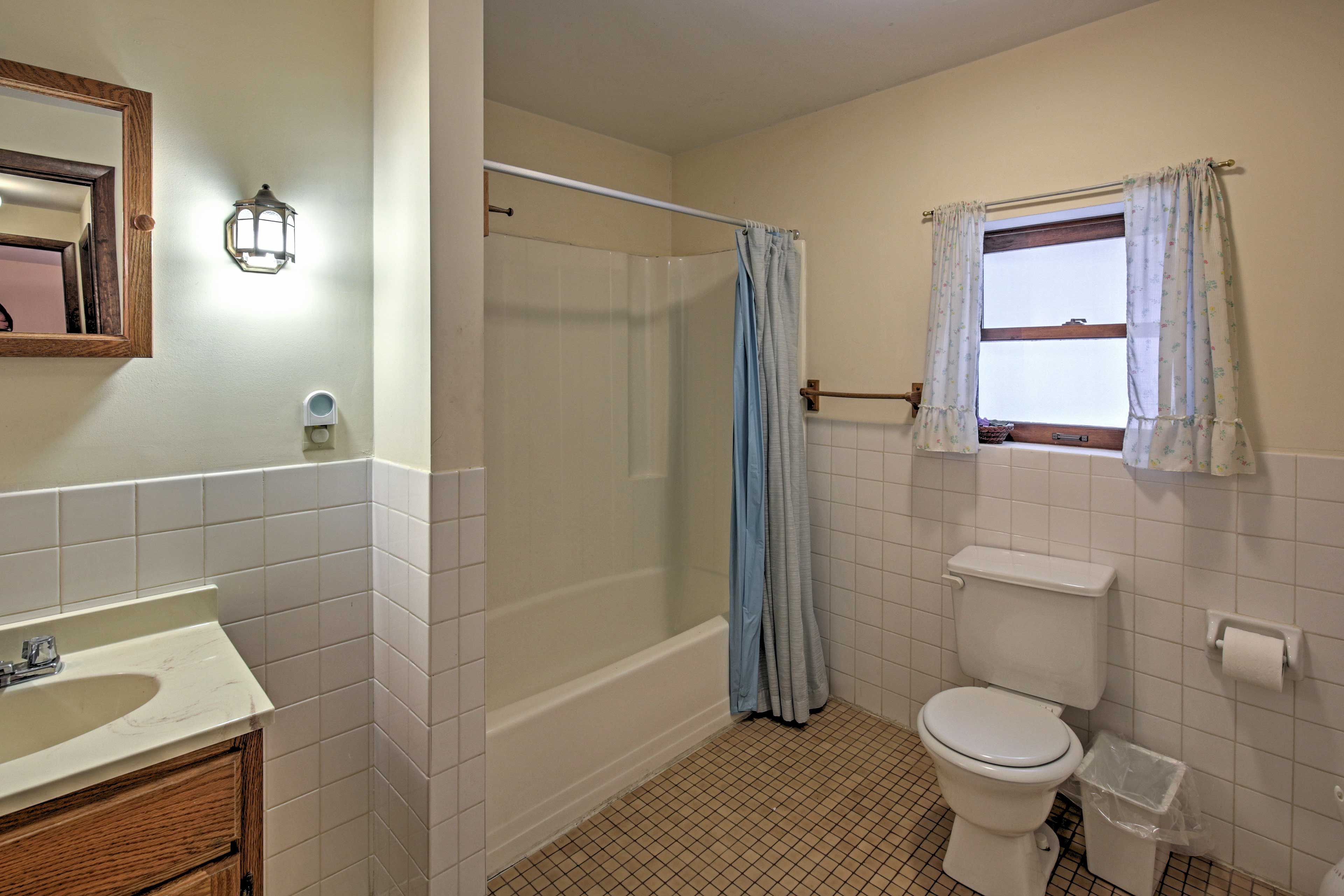 Another bathroom includes a shower/tub combo.