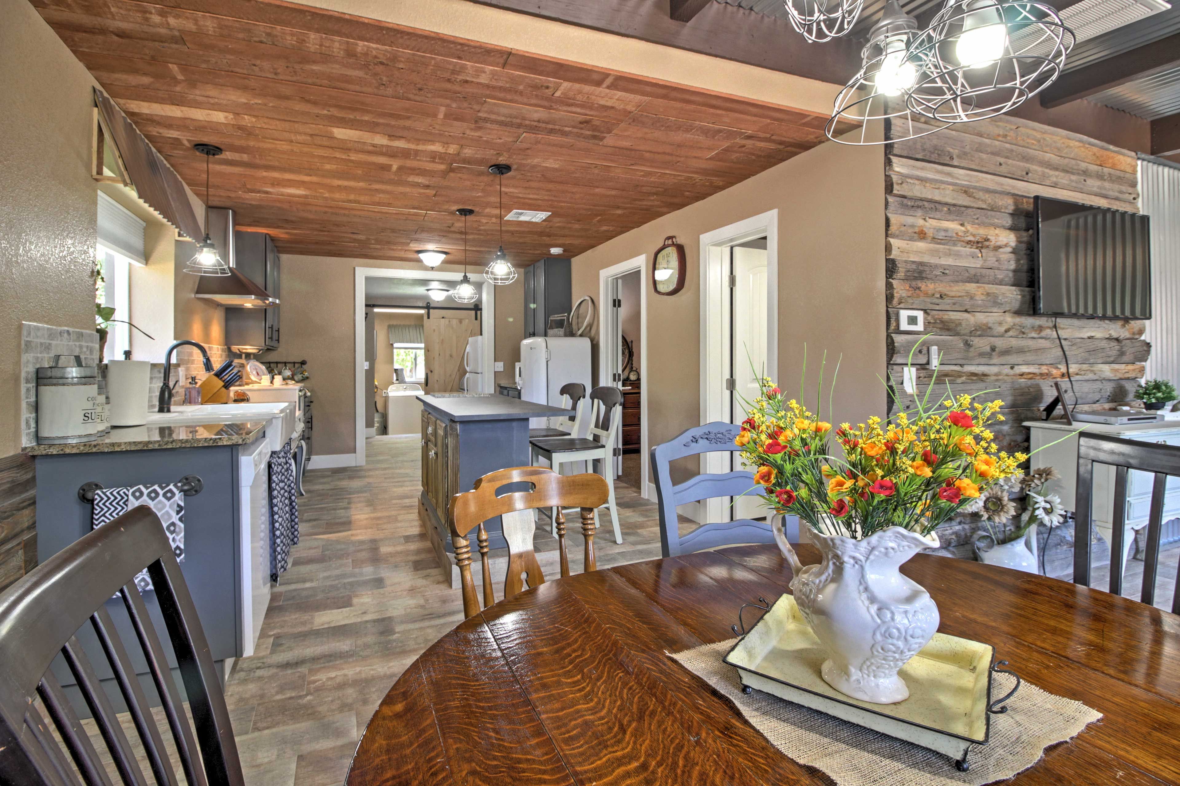 The kitchen has granite countertops and an antique 4-burner electric stove.