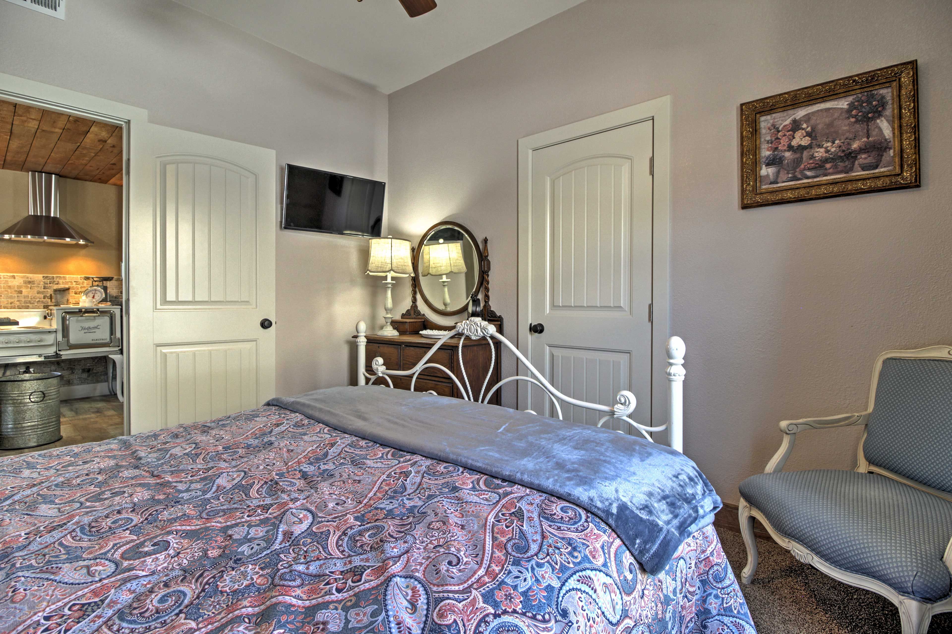 The rooms are outfitted with wooden dressers, ample closet space, and queen beds.