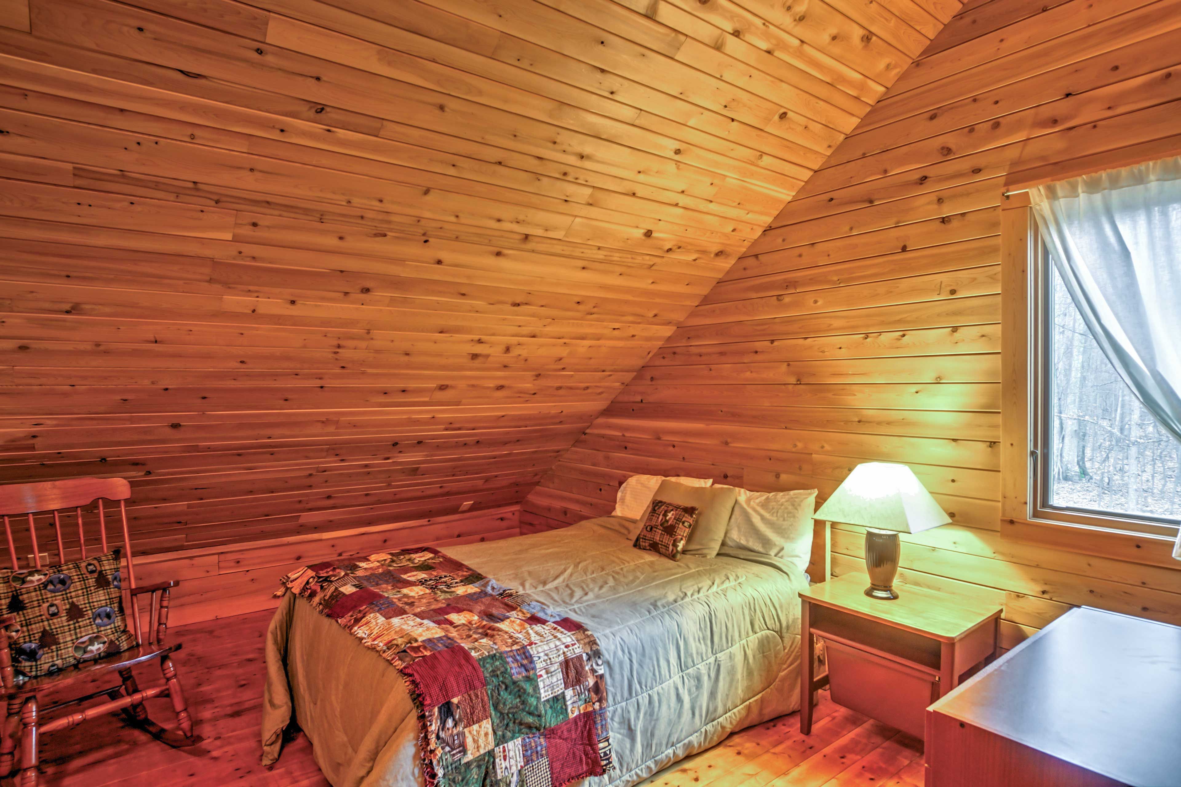 The loft area is complete with a full-sized bed and a twin-sized futon bed.
