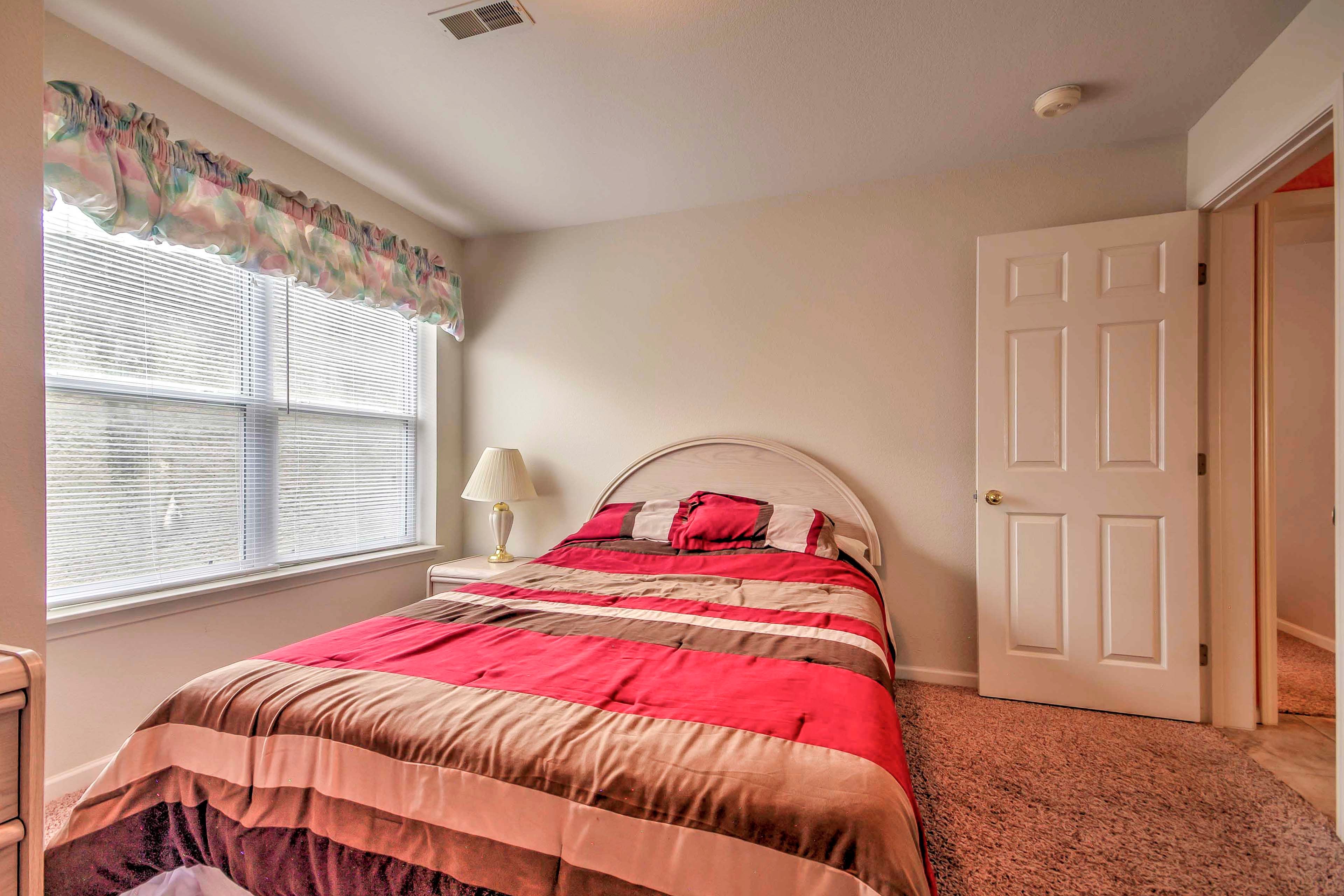This bedroom features a queen-sized bed and simple decor.