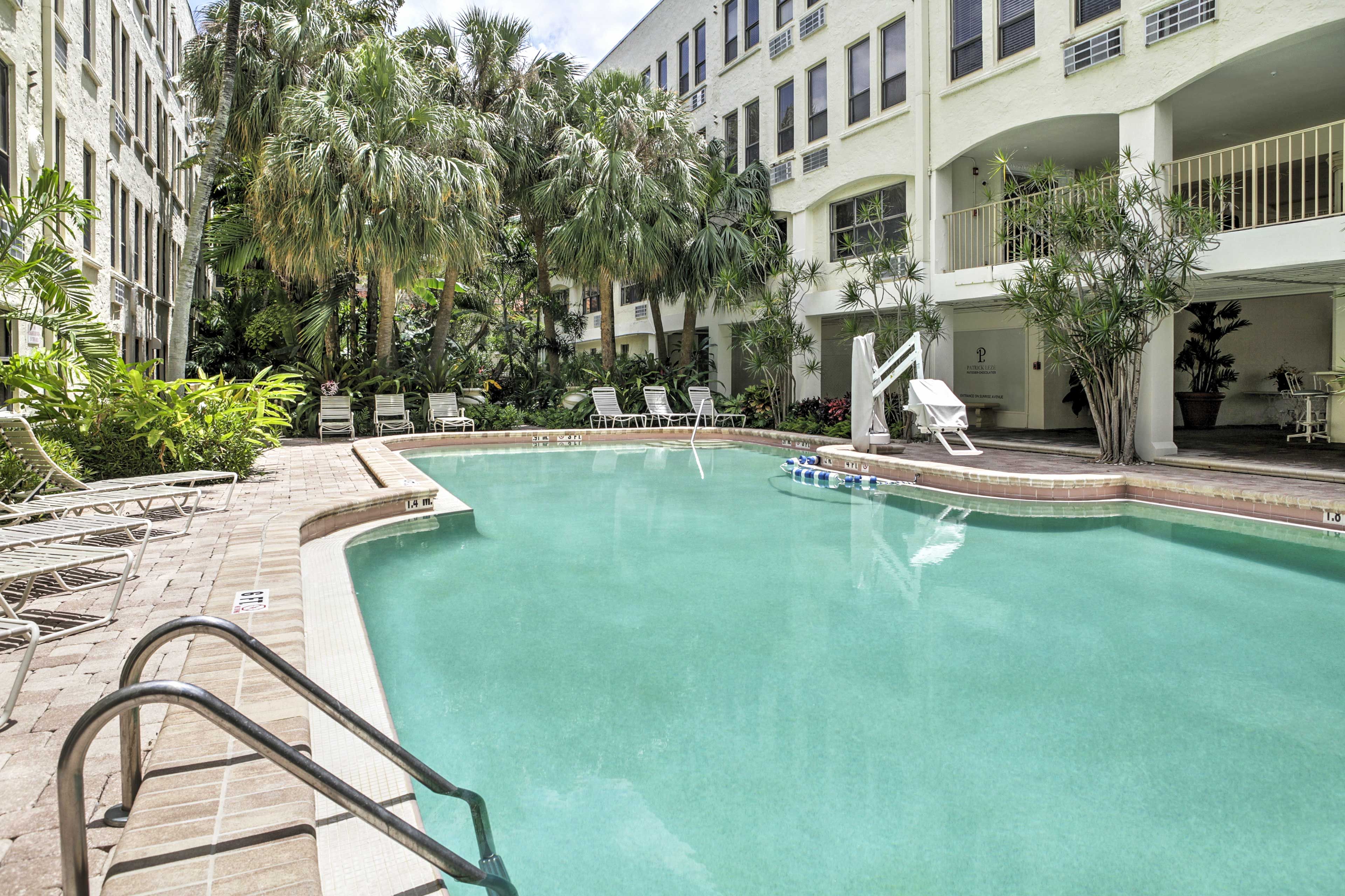 Jump in the pool, which is surrounded by tropical palms.