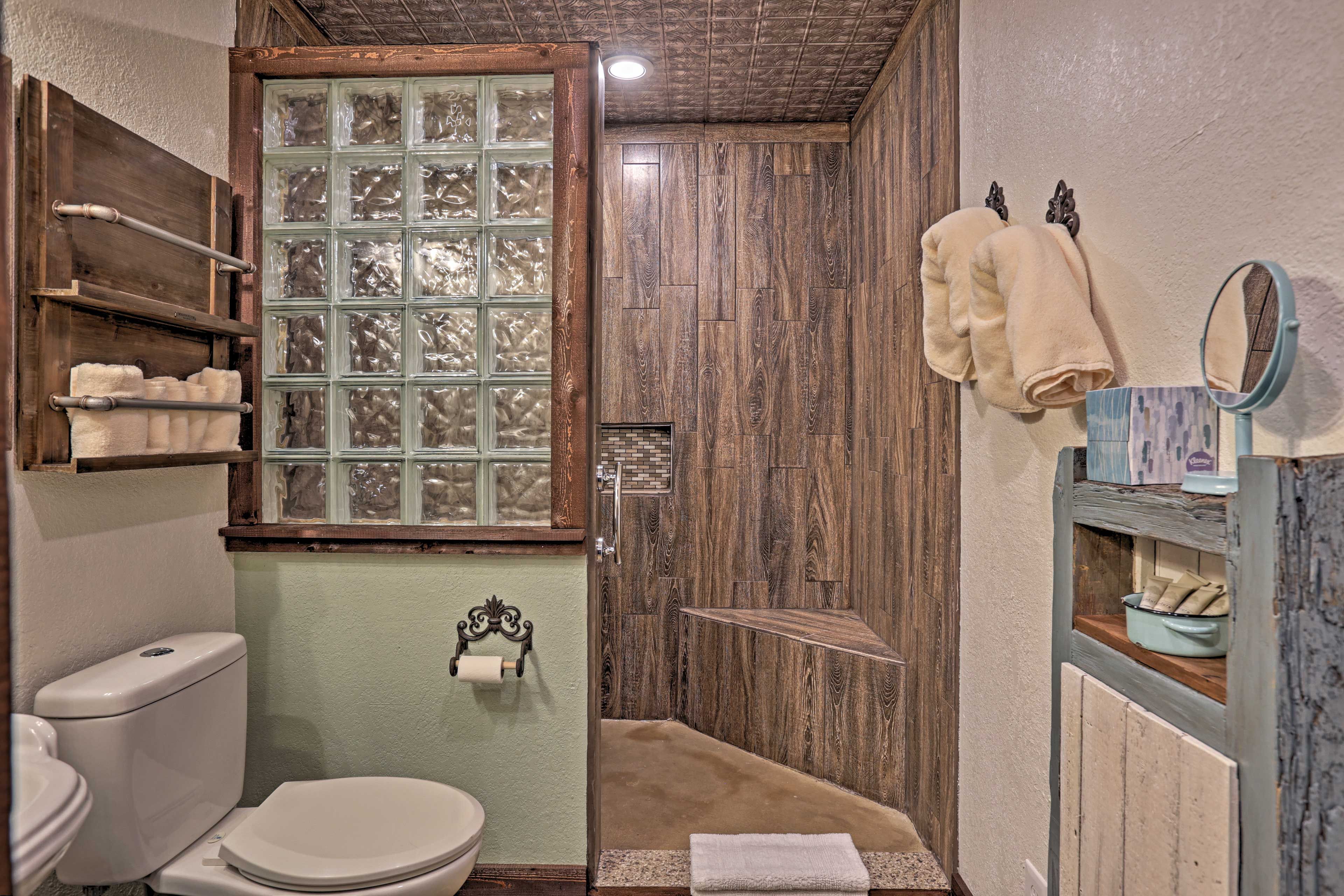 A custom-made sliding barn door welcomes you into a newly updated full bathroom.