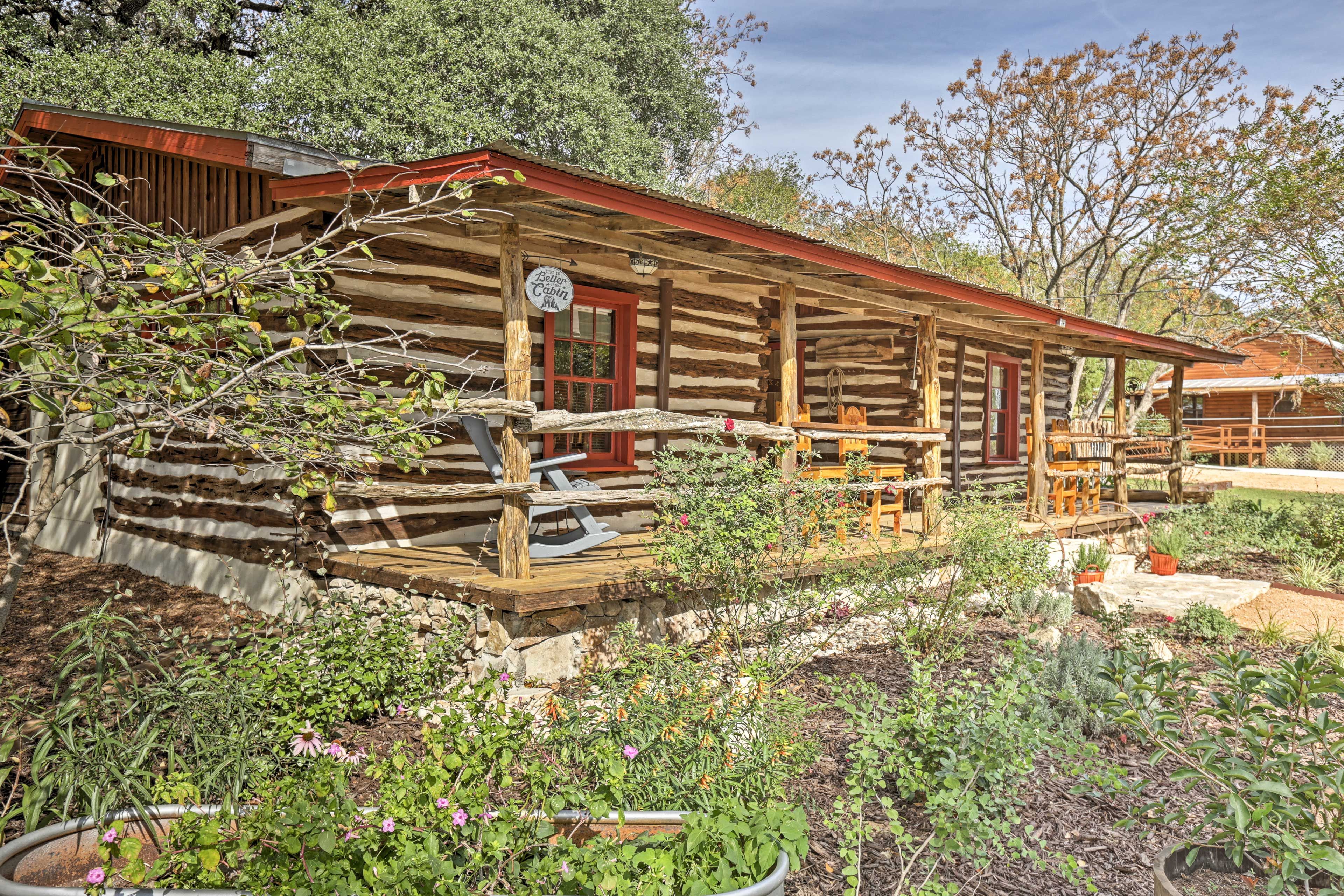 Rose gardens, fruit trees, and towering oaks surround the property.