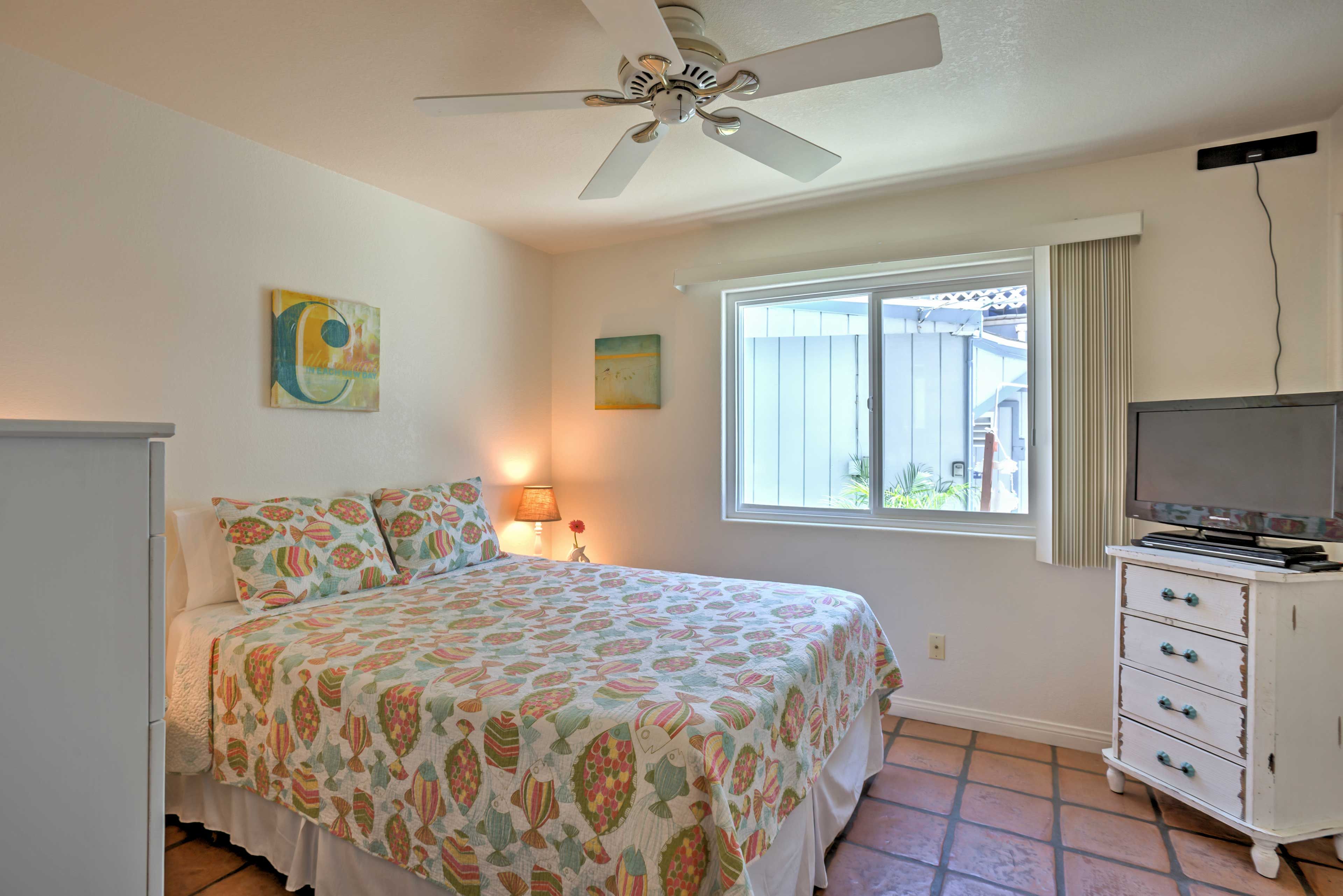 This bedroom features a queen bed and flat screen TV.