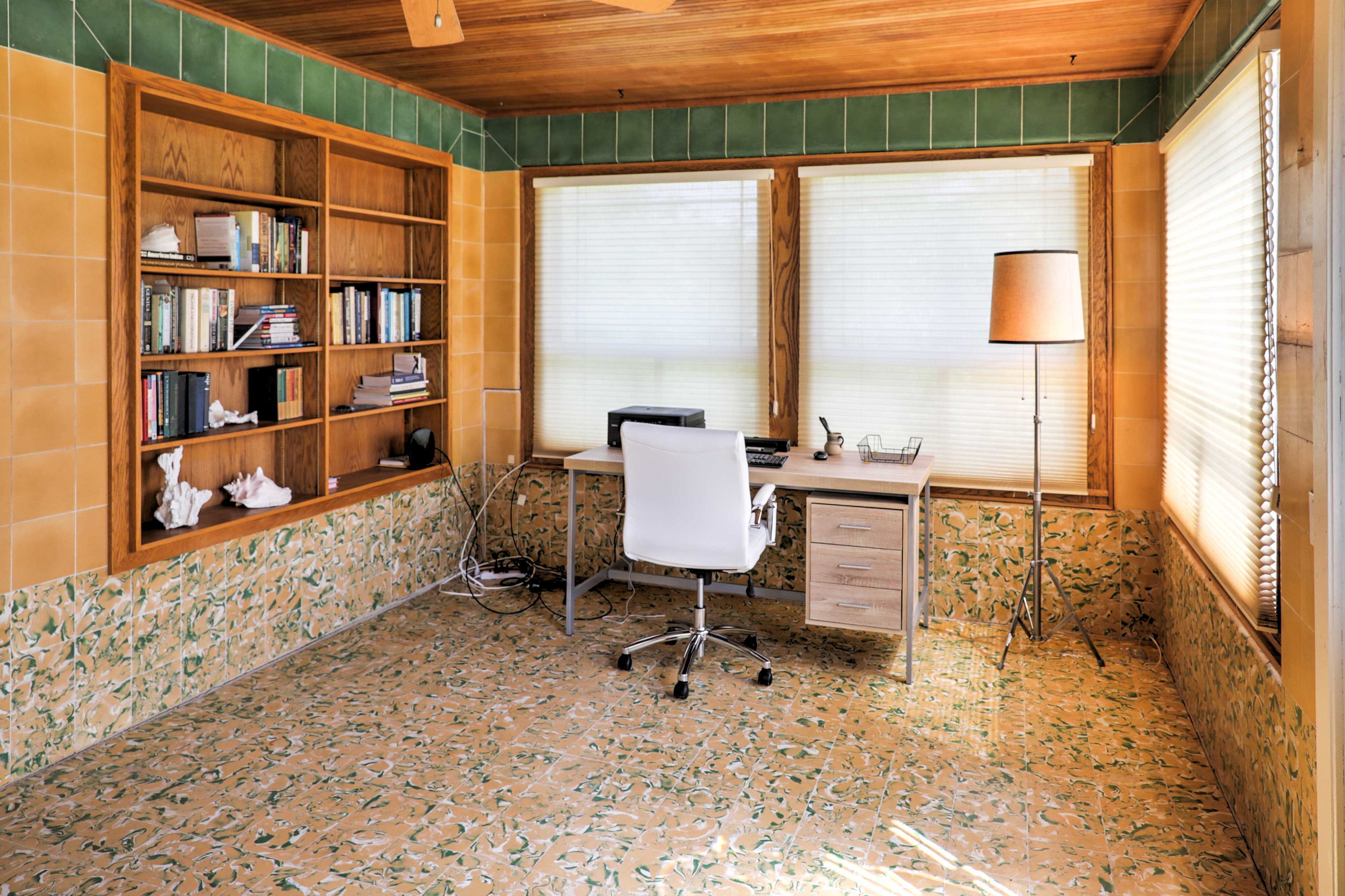 Downstairs is a second living area and home office, complete with a large desk.