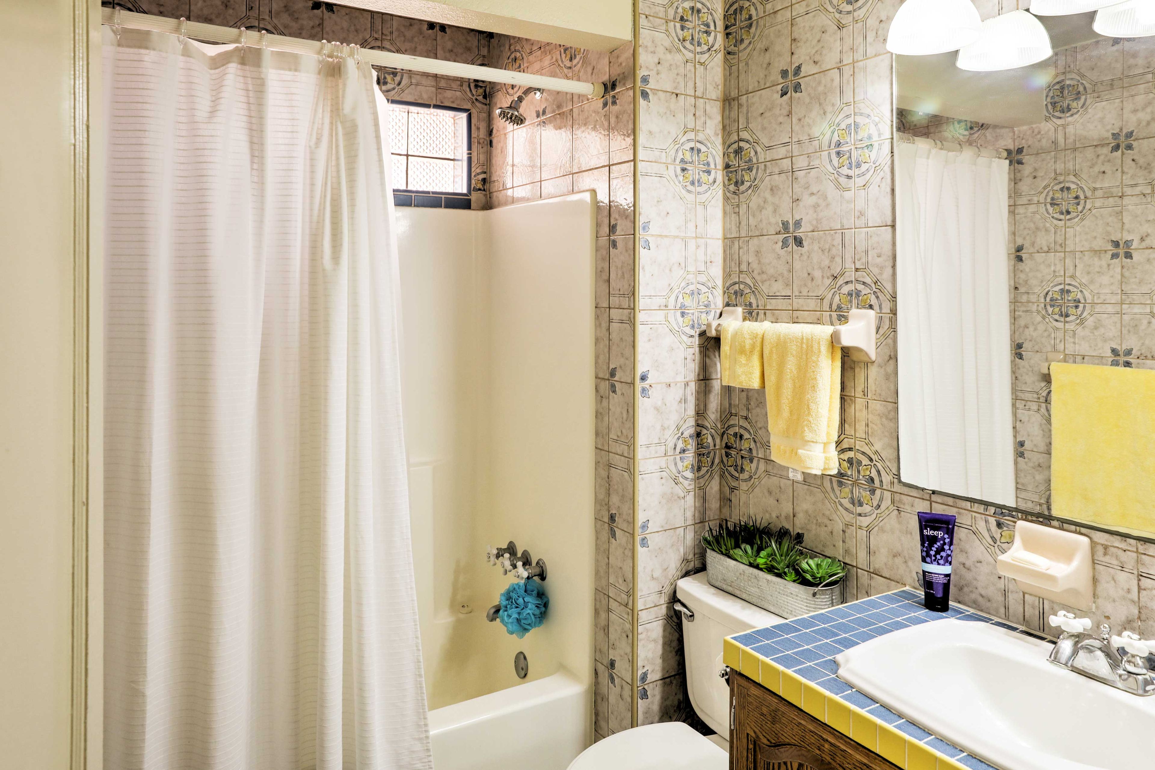The full bathroom houses a tub/shower combo.