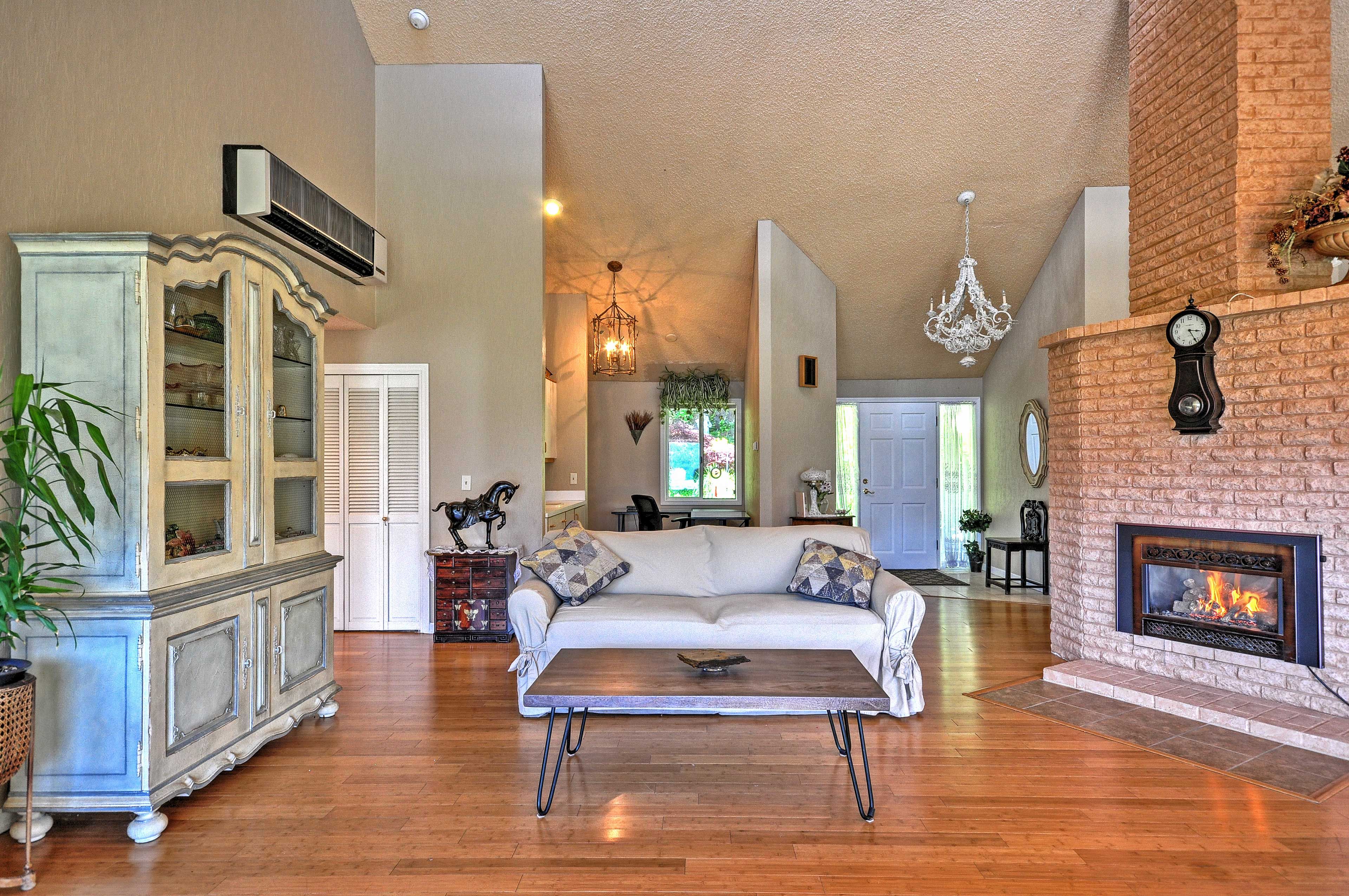 The open, high-ceiling living and dining room areas have rich bamboo floors.