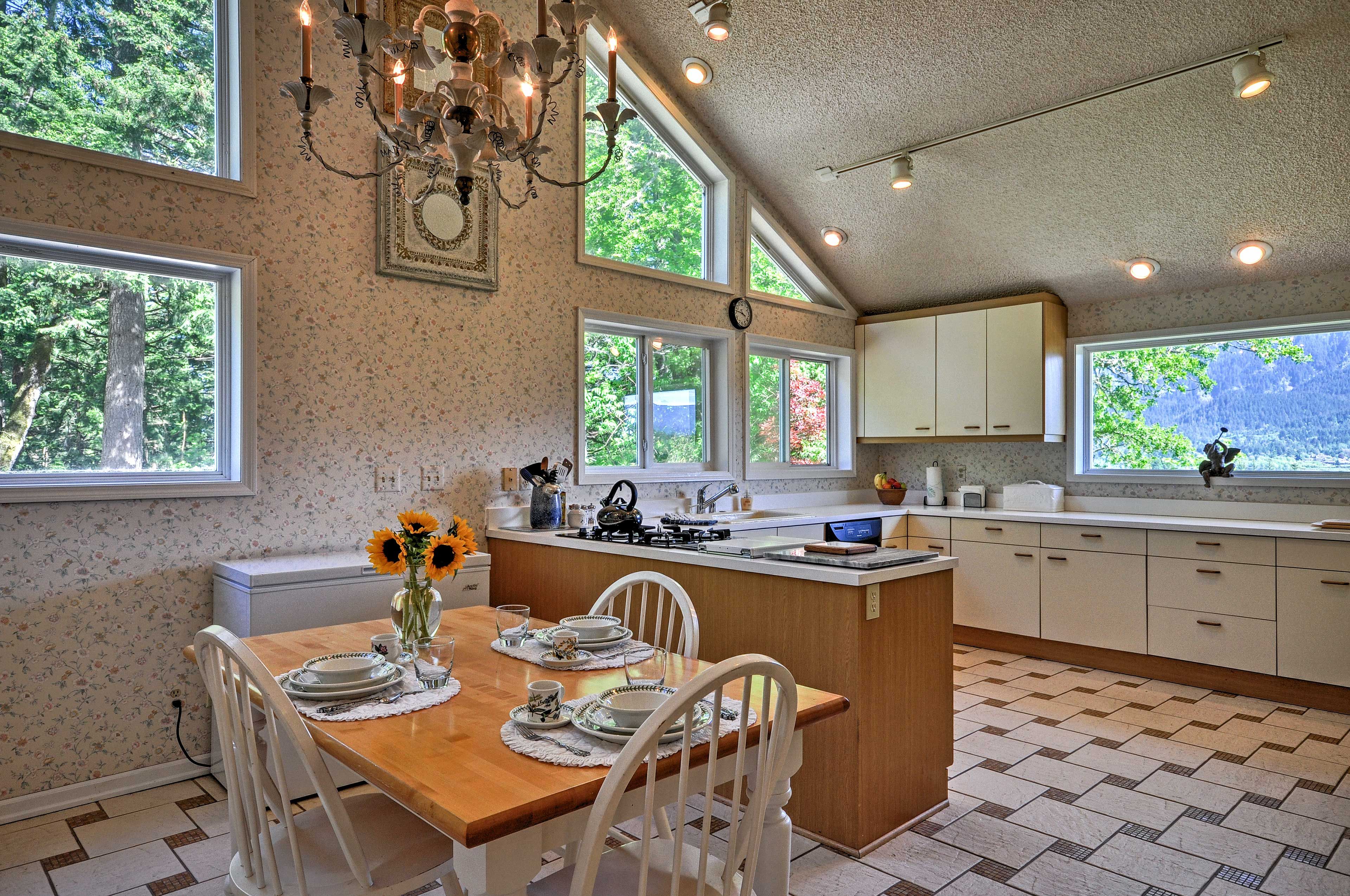 The fully equipped eat-in kitchen has ceramic tile floors & custom German cabinetry.