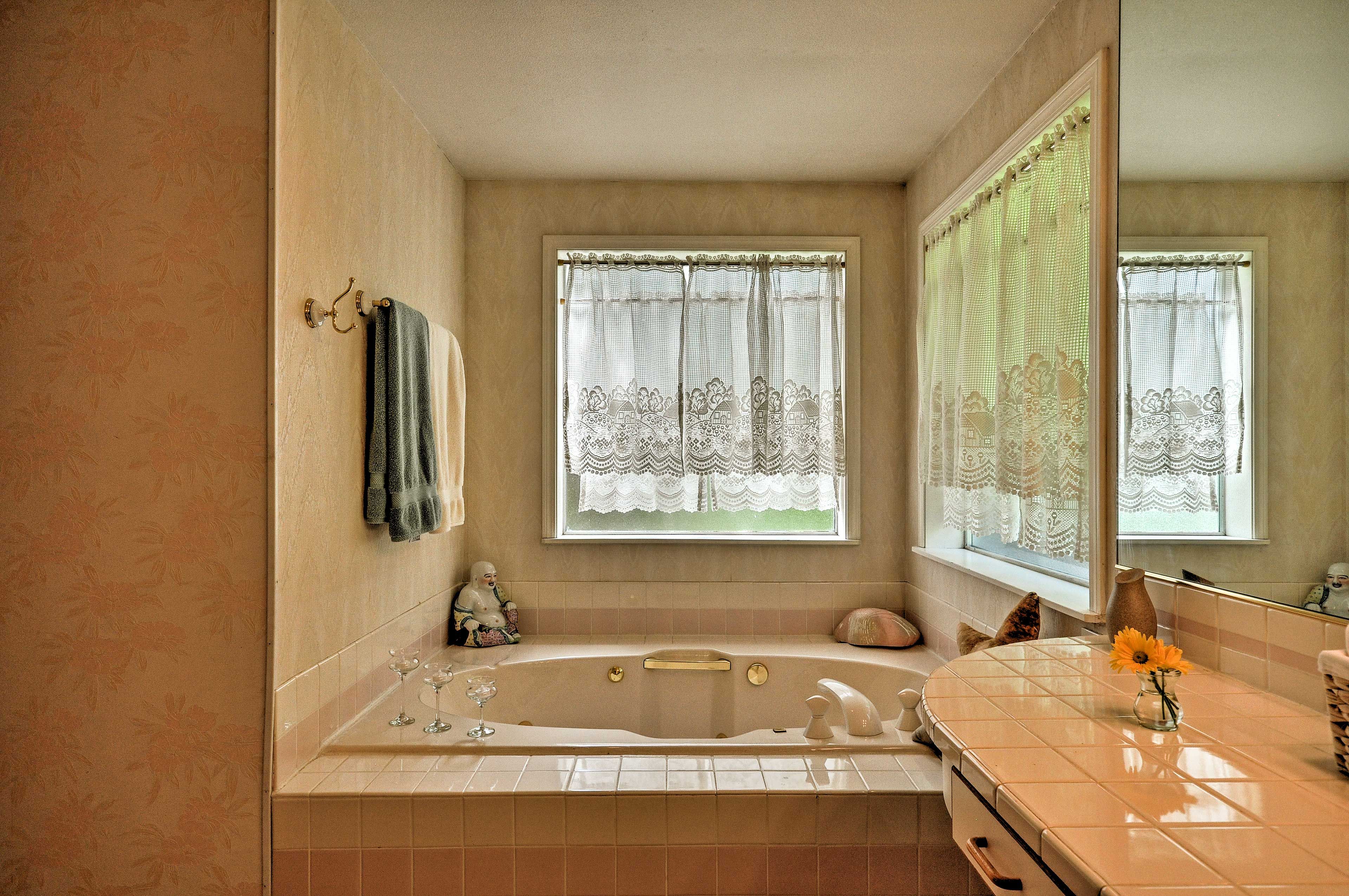 The bathroom features a double walk-in shower and an inviting Jacuzzi.