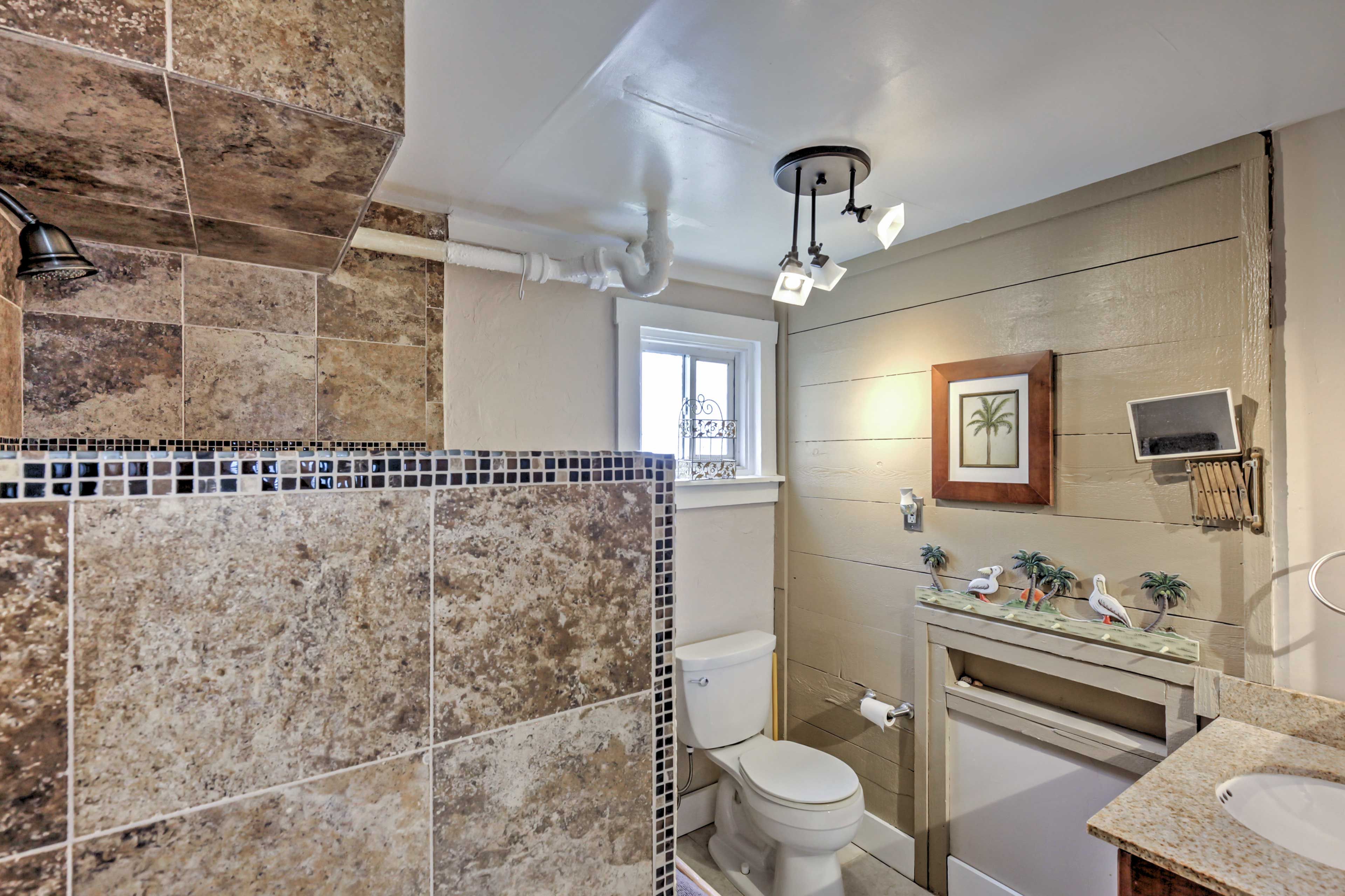 The pristine bathroom features a beautiful walk-in shower.
