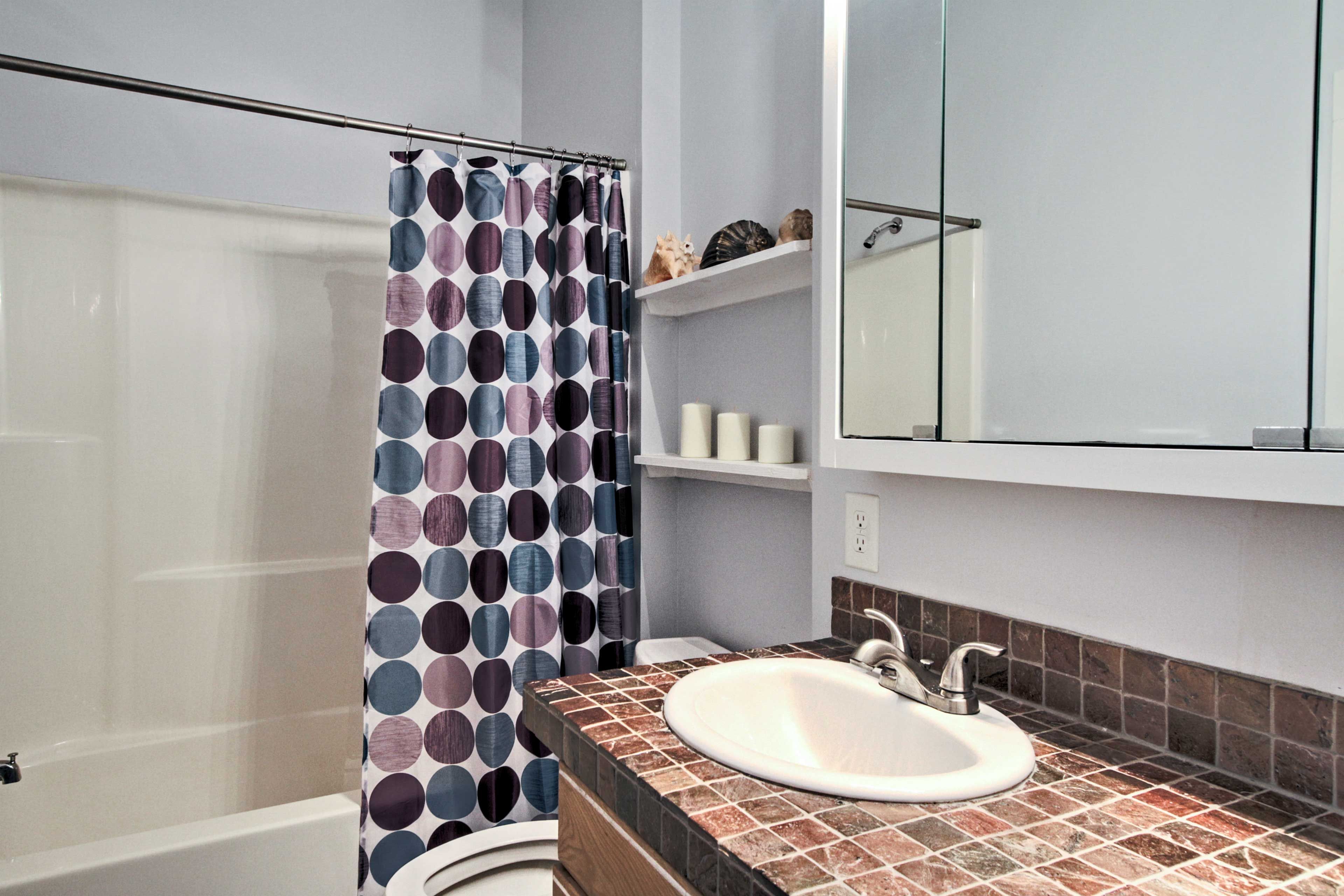 Tasteful decorations add a pop of personality to each bathroom.