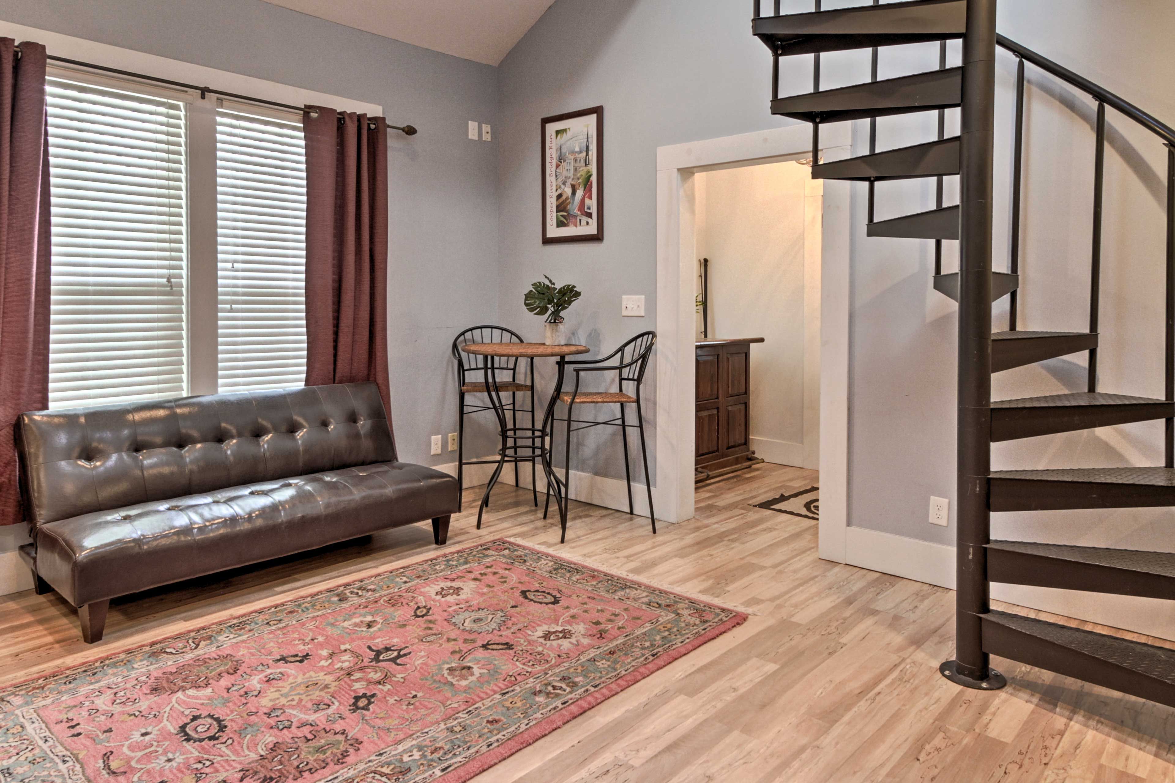 Travel up the spiral staircase to access the loft area.