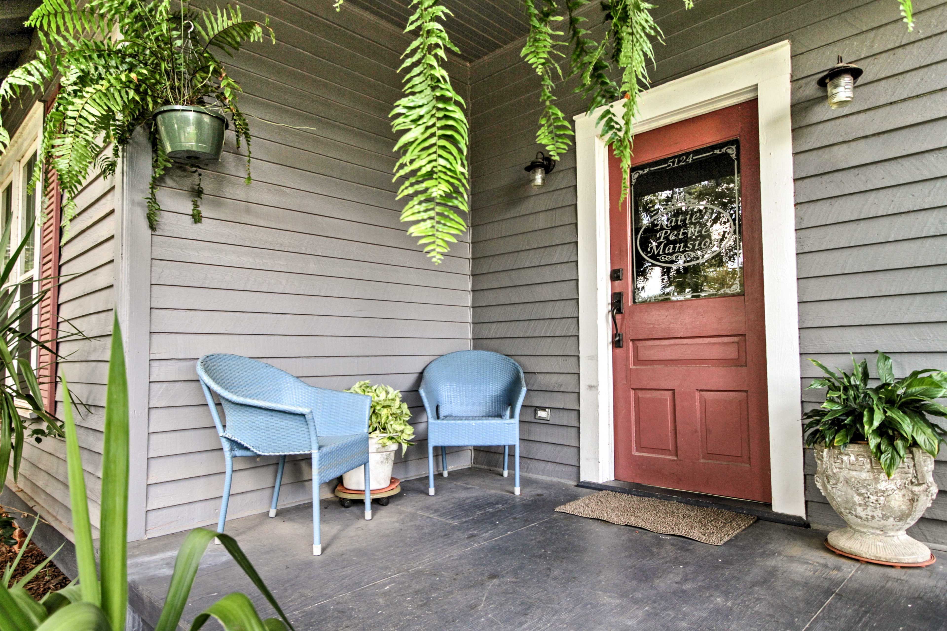 The quaint front porch invites you inside this petite mansion.