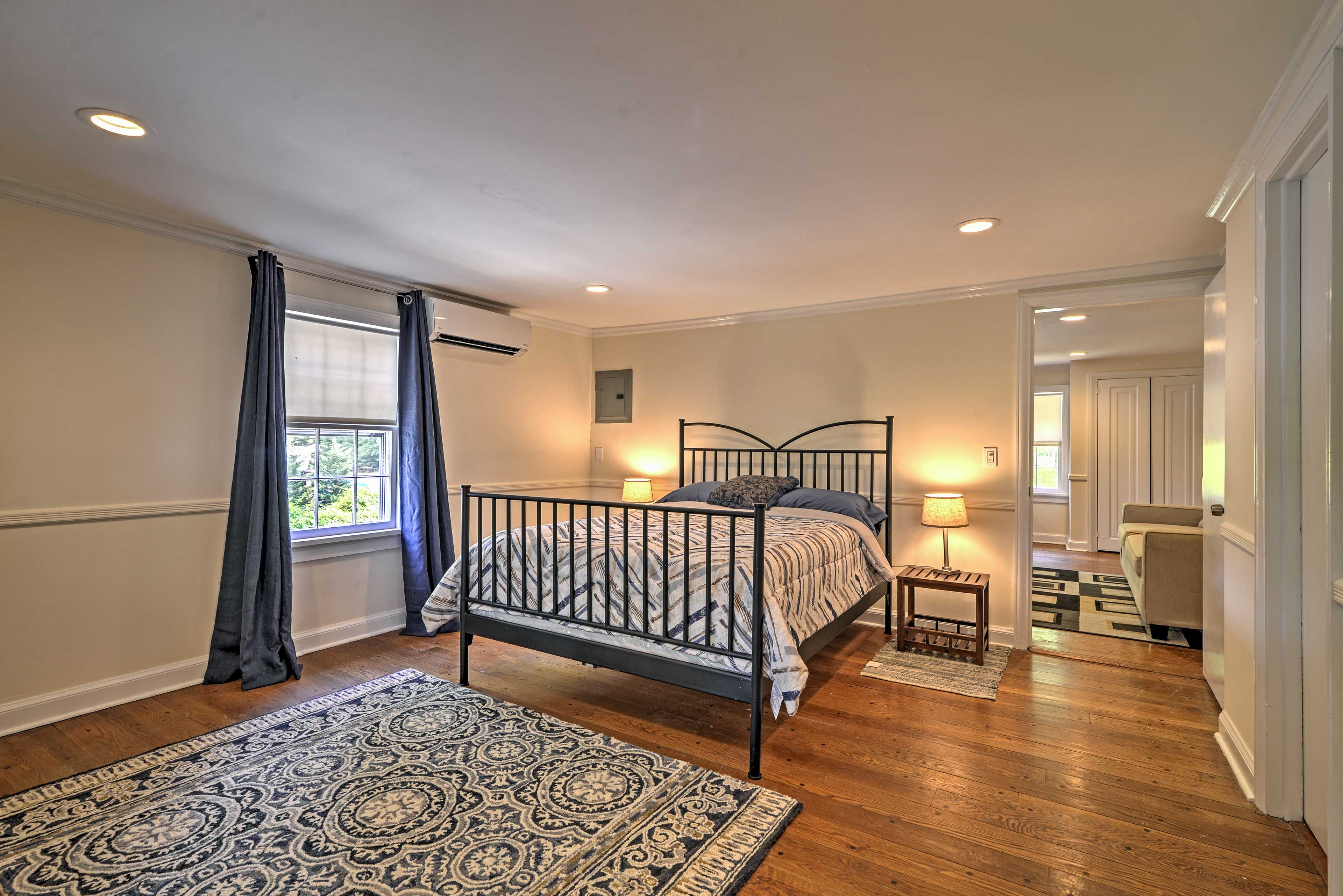 This spacious bedroom comes equipped with a plush queen-sized bed for your best night's sleep.