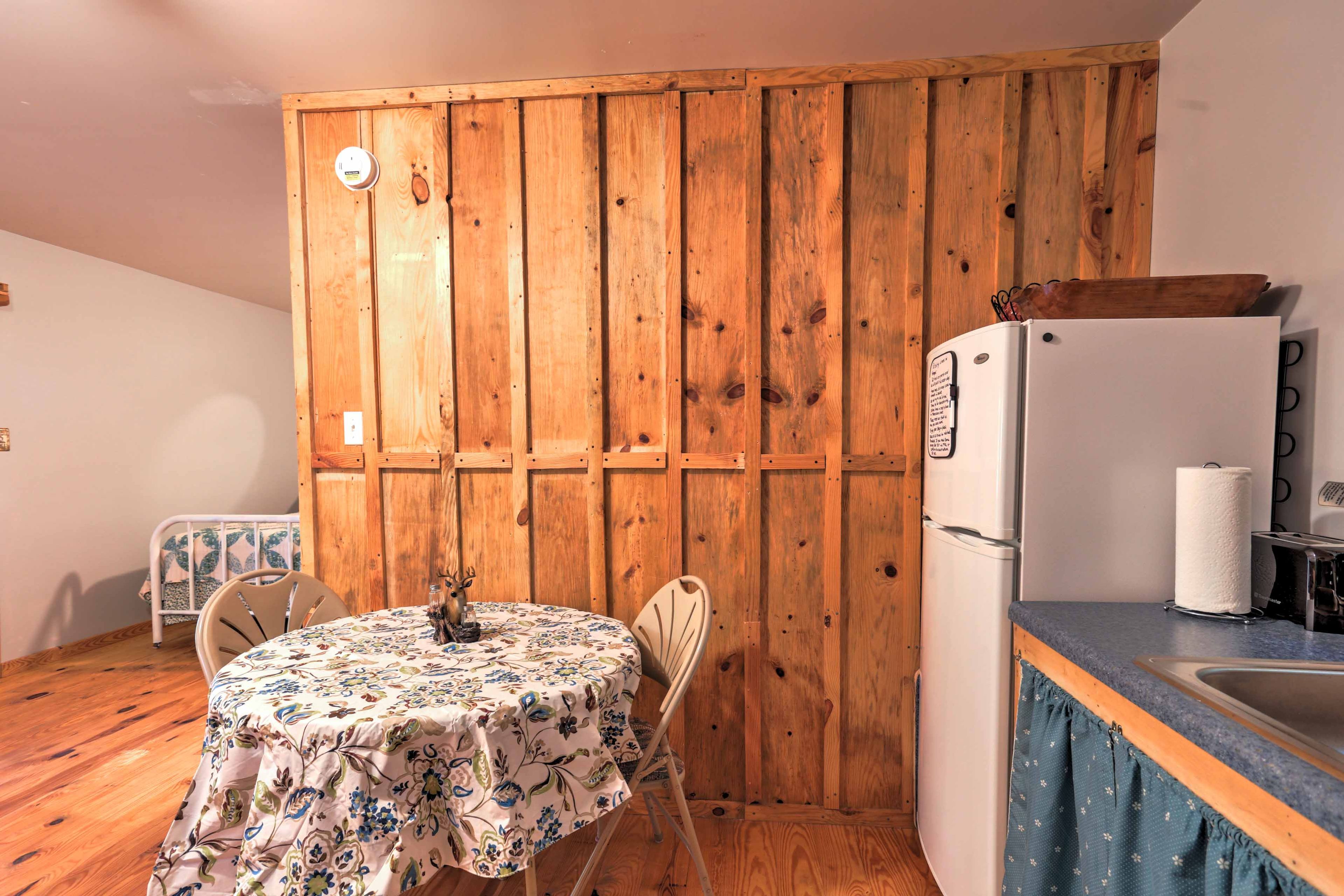 Two guests can enjoy their meals at the dining table in the kitchen.