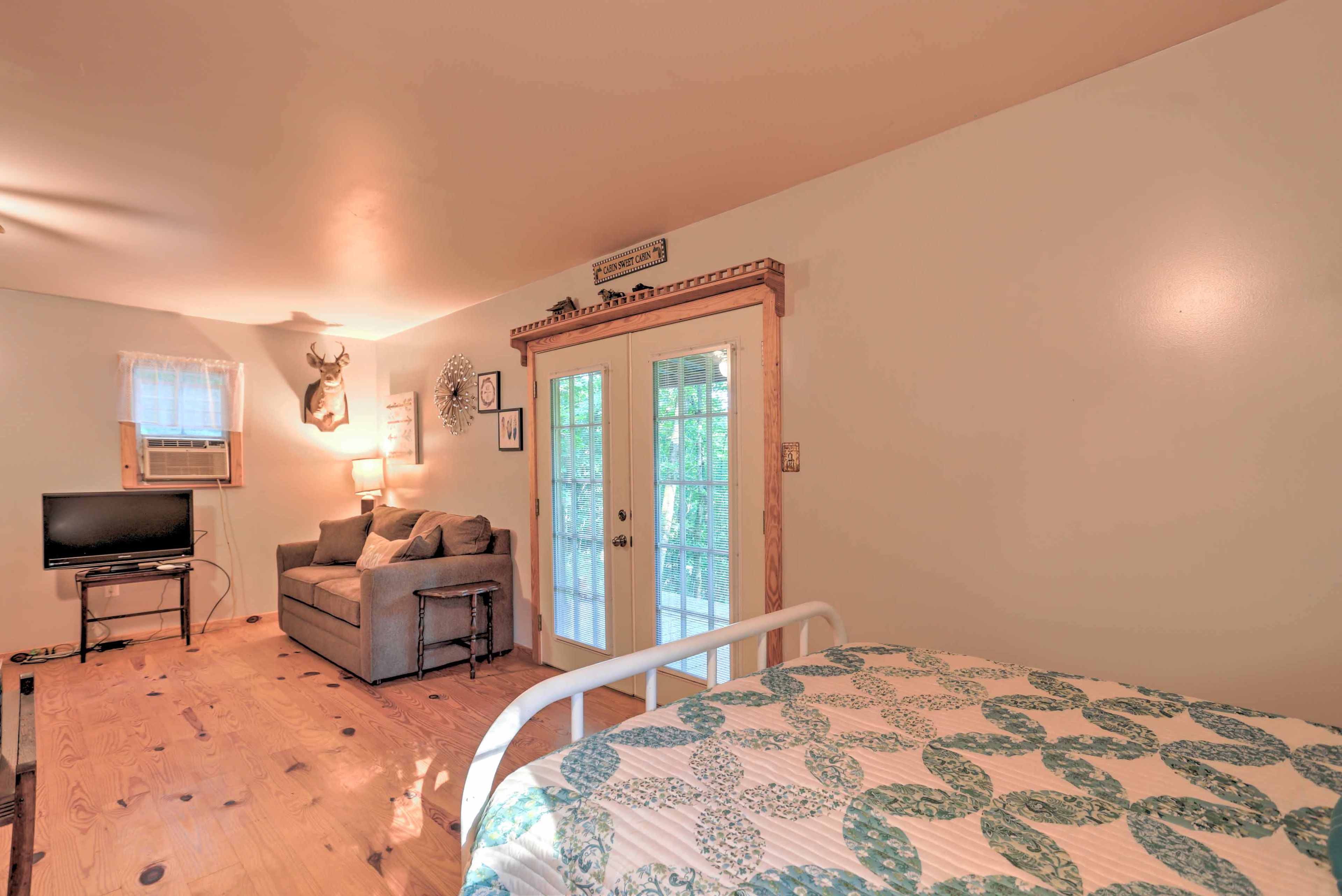 The cabin features an open floor plan and unique hardwood floors.