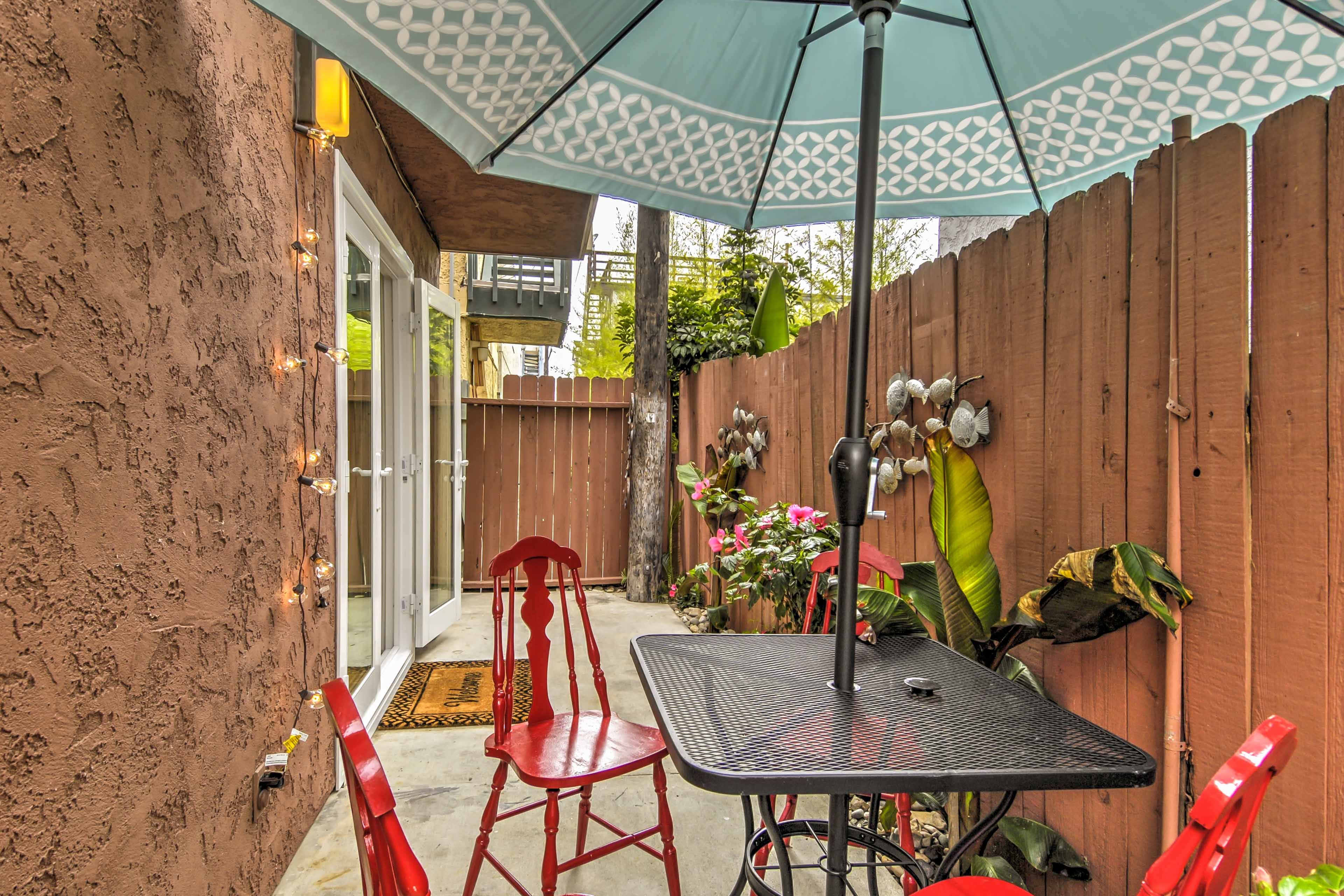 Host happy hour seated beneath a cool umbrella.