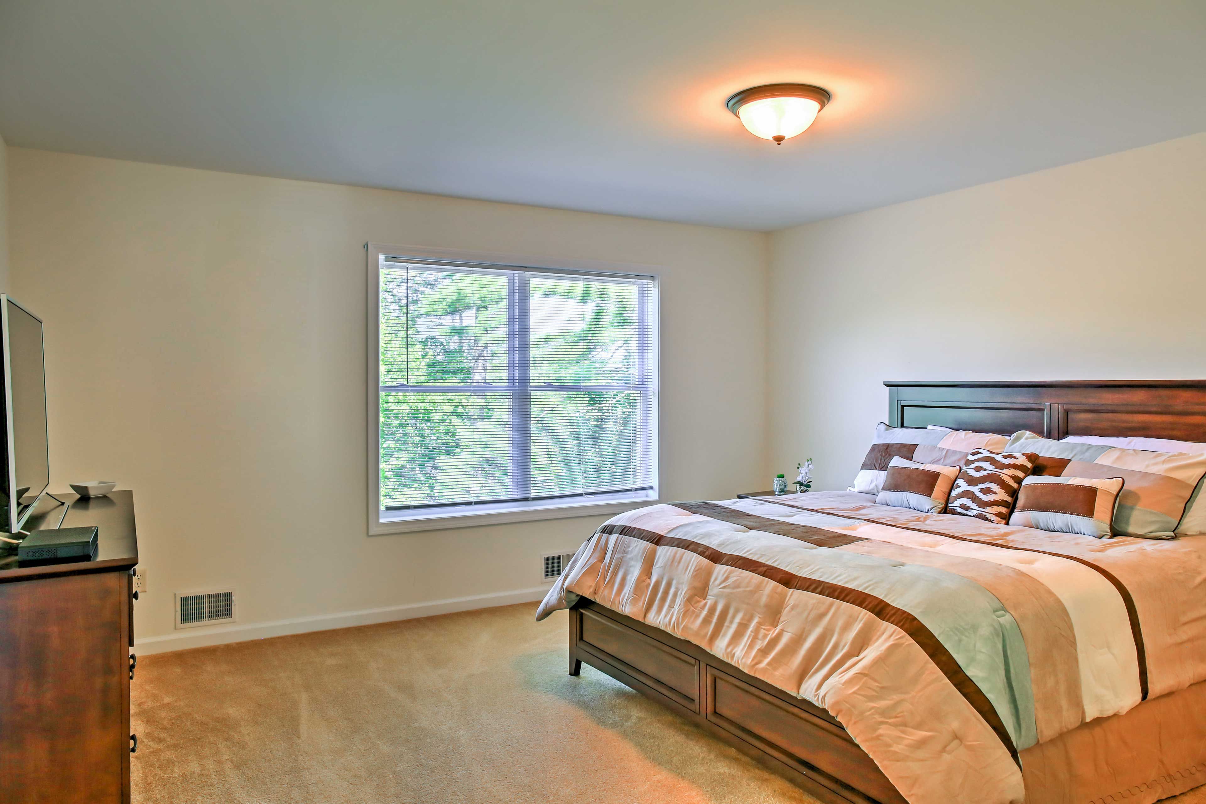 The first bedroom boasts a king bed, flat-screen TV and en-suite bathroom.