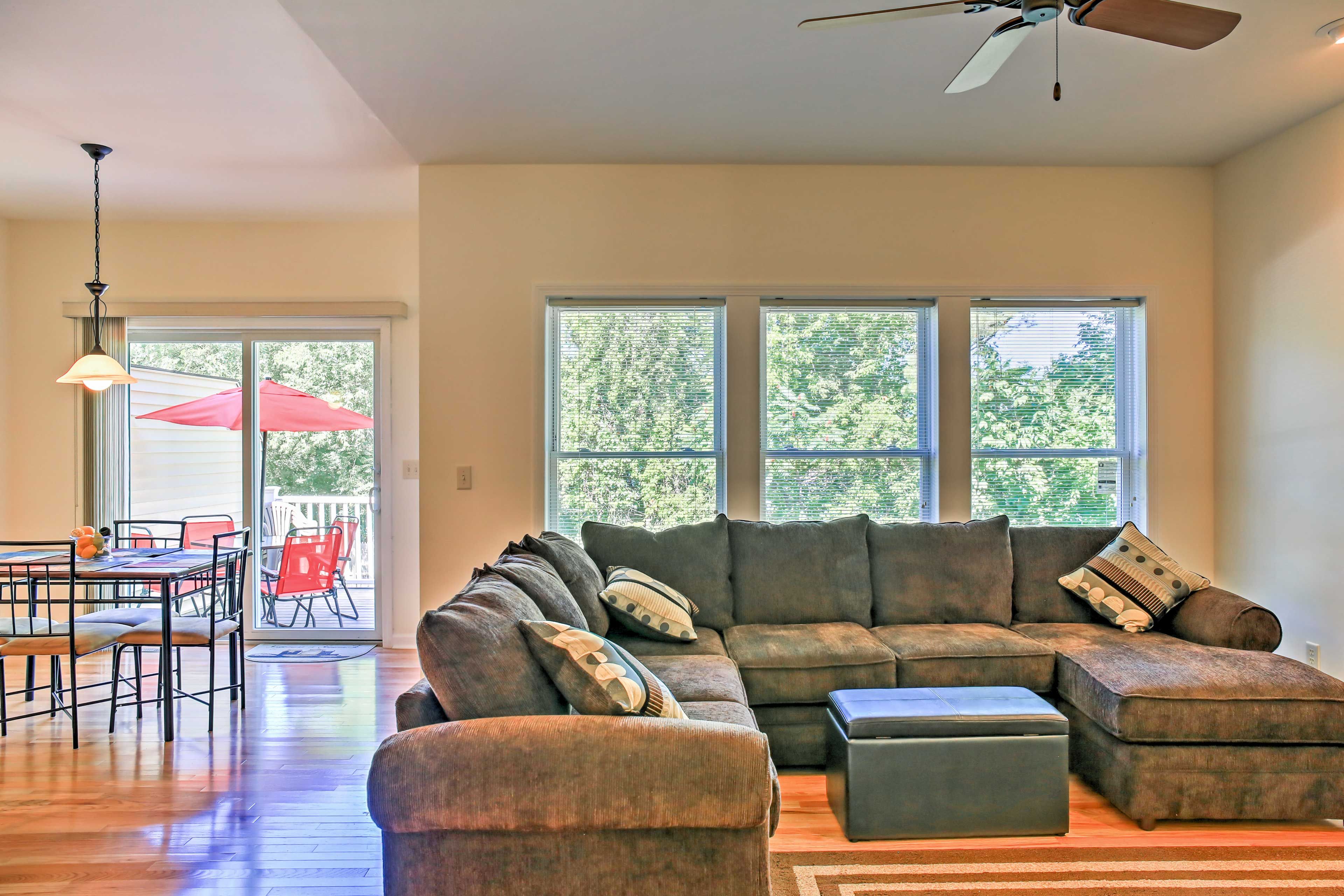 The den features a large sectional couch.