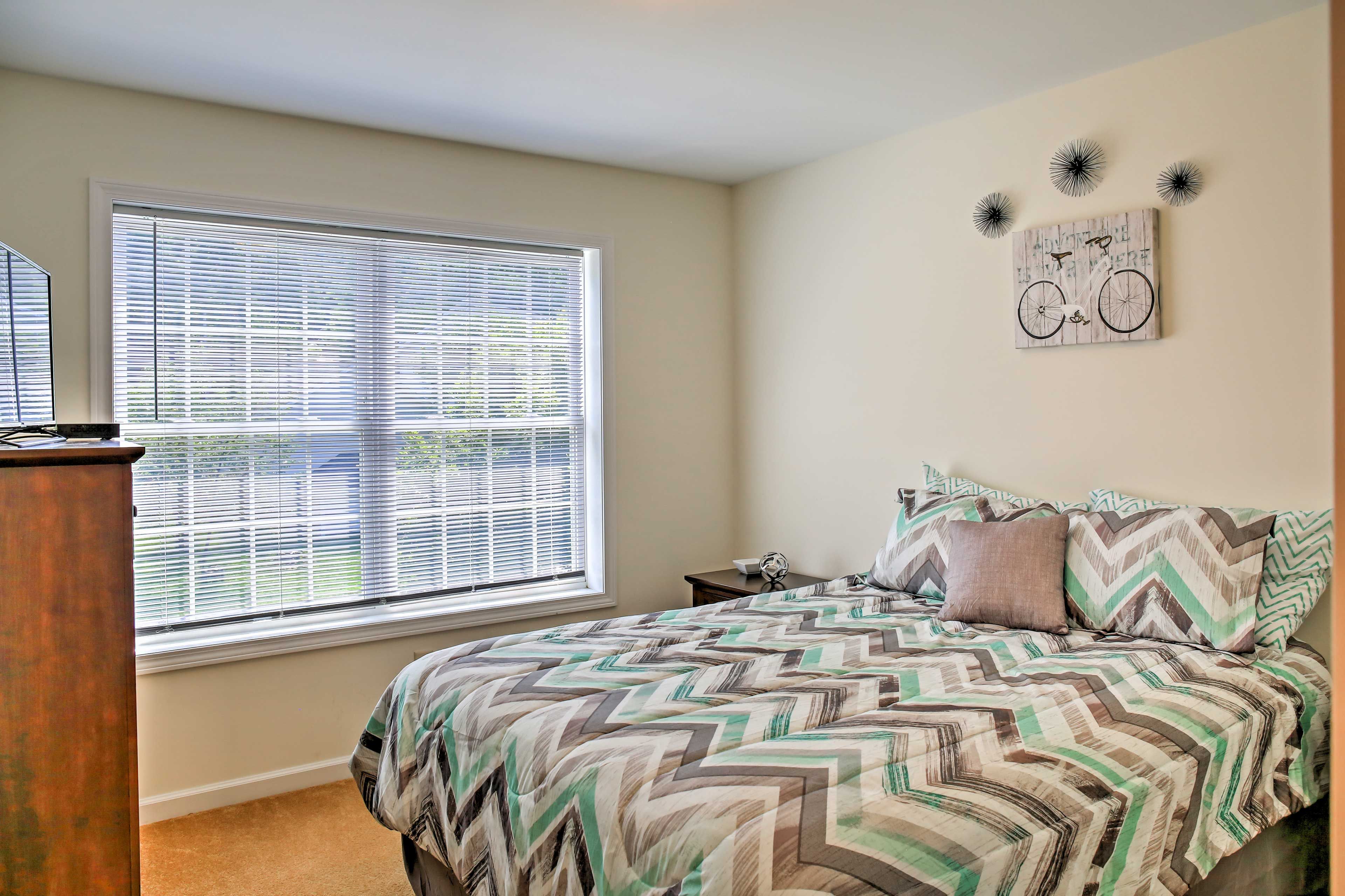 This bedroom offers a comfortable queen bed and flat-screen TV.