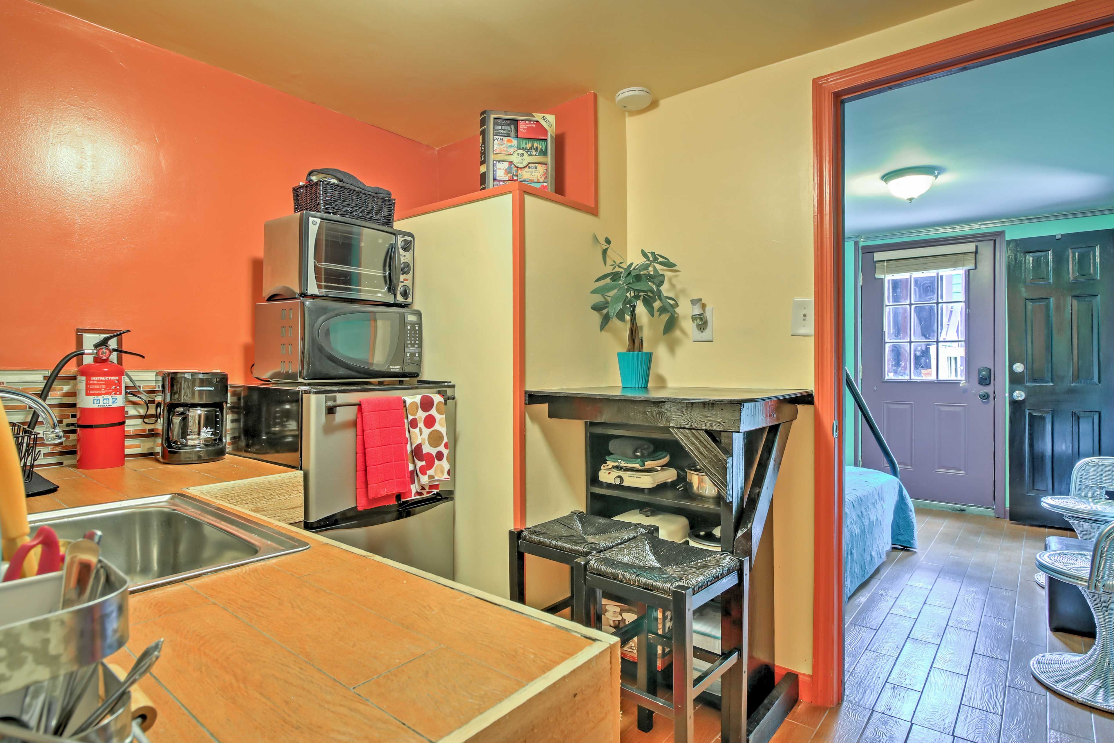 Two guests can play a game or enjoy a meal together at the table in the kitchen.