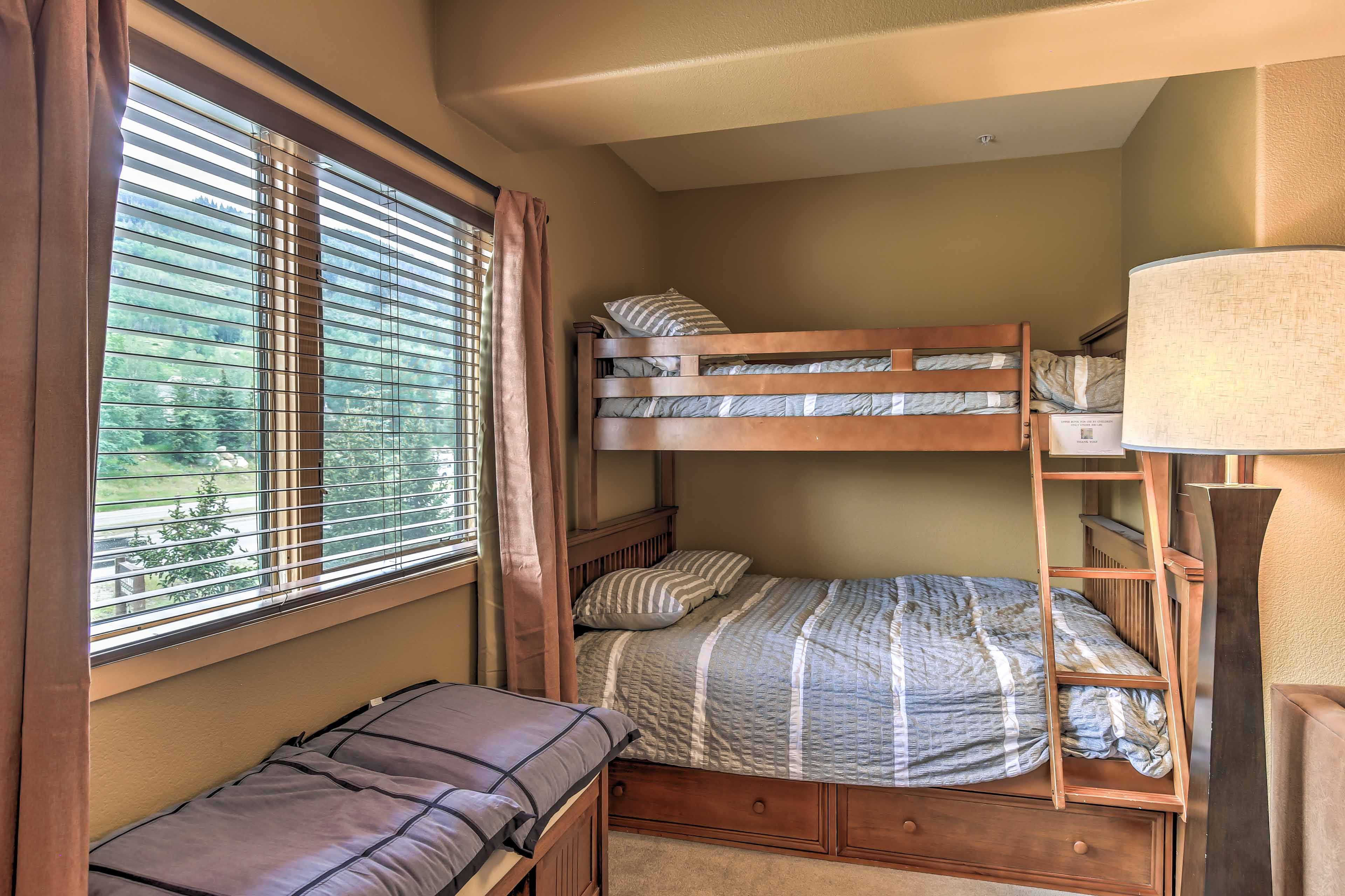 A cozy sleeping nook features a twin-over-full bunk bed.