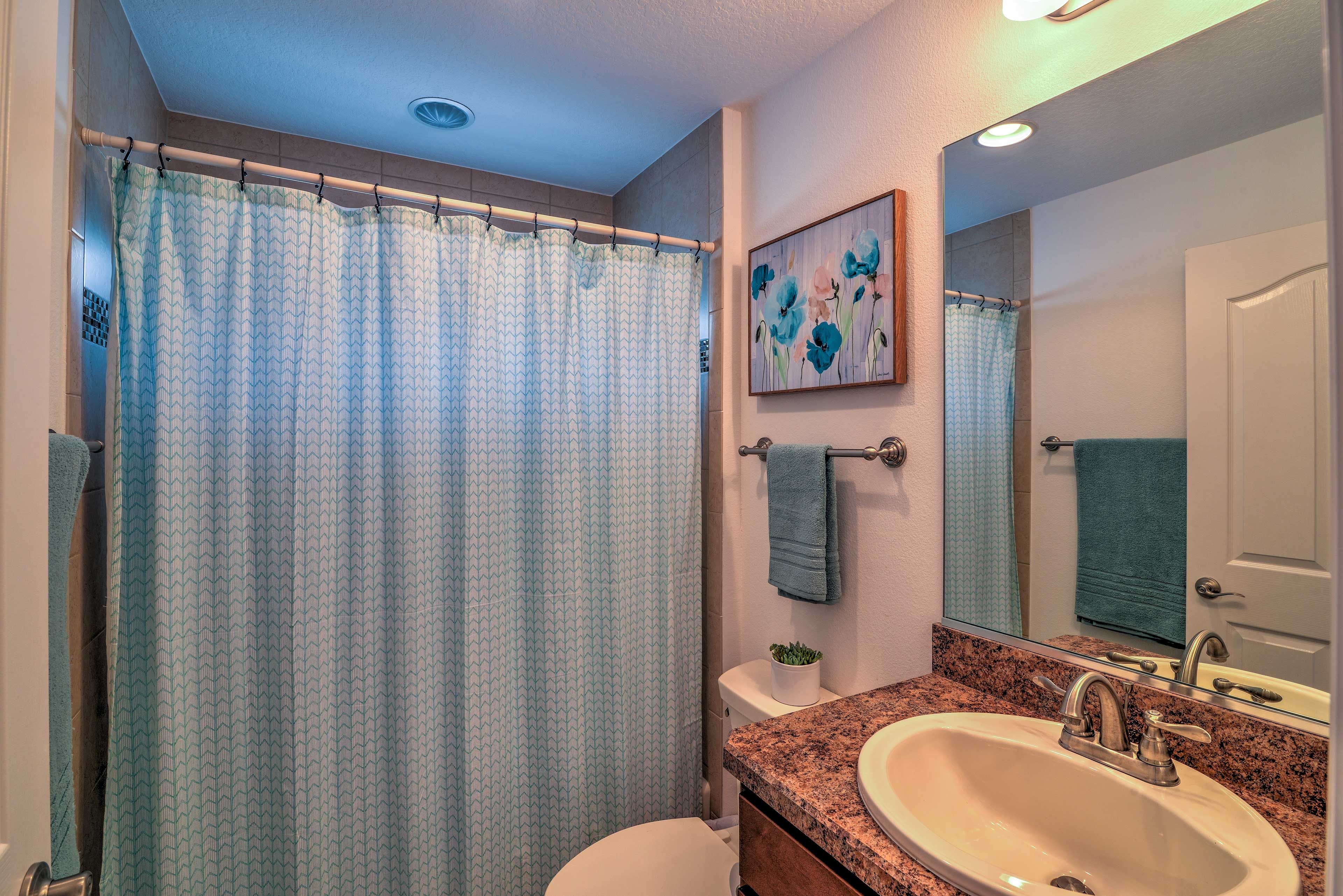 Wash up before bed in this full bathroom.