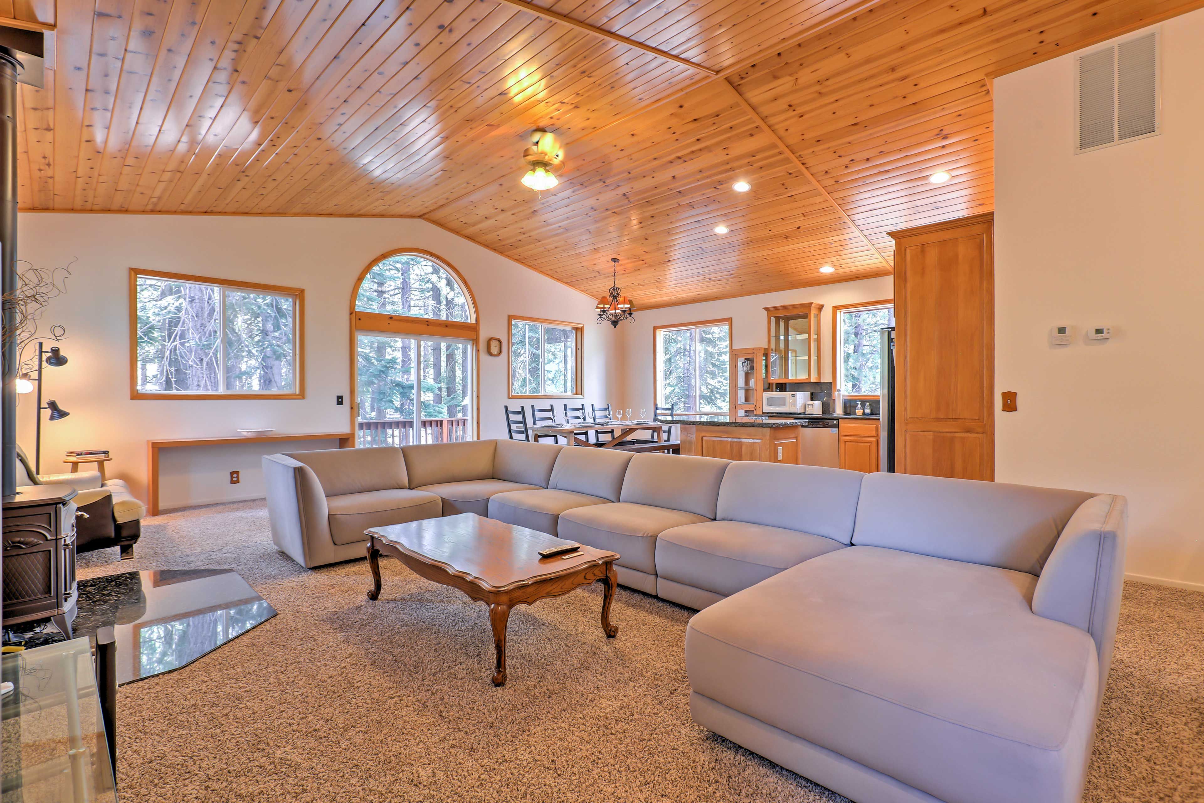 The home's interior boasts vaulted wood ceilings and an open-concept layout.