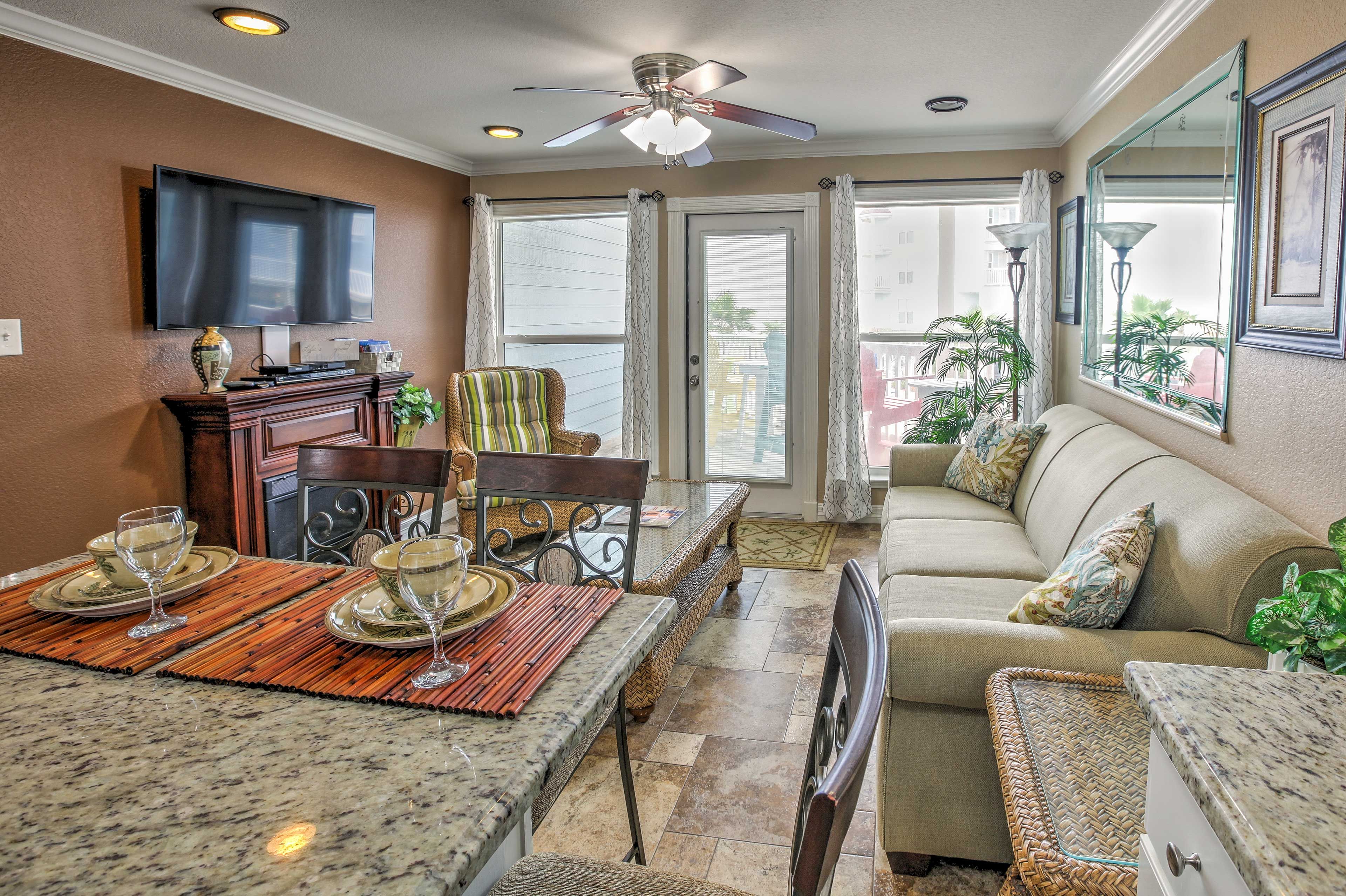 Natural light floods the main living space through the large windows and door that leads out to the private balcony.
