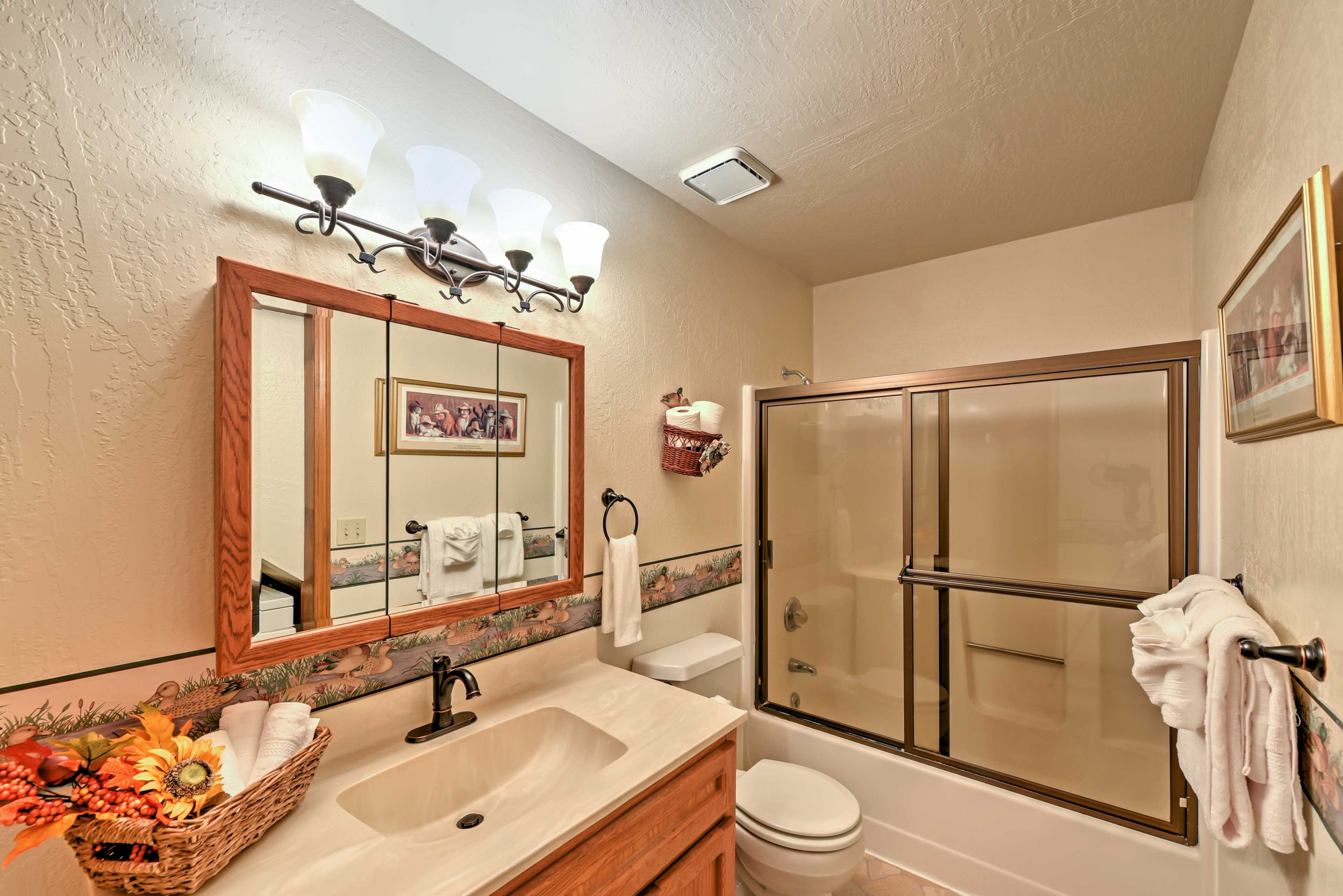 The bathroom offers a shower/tub combo.