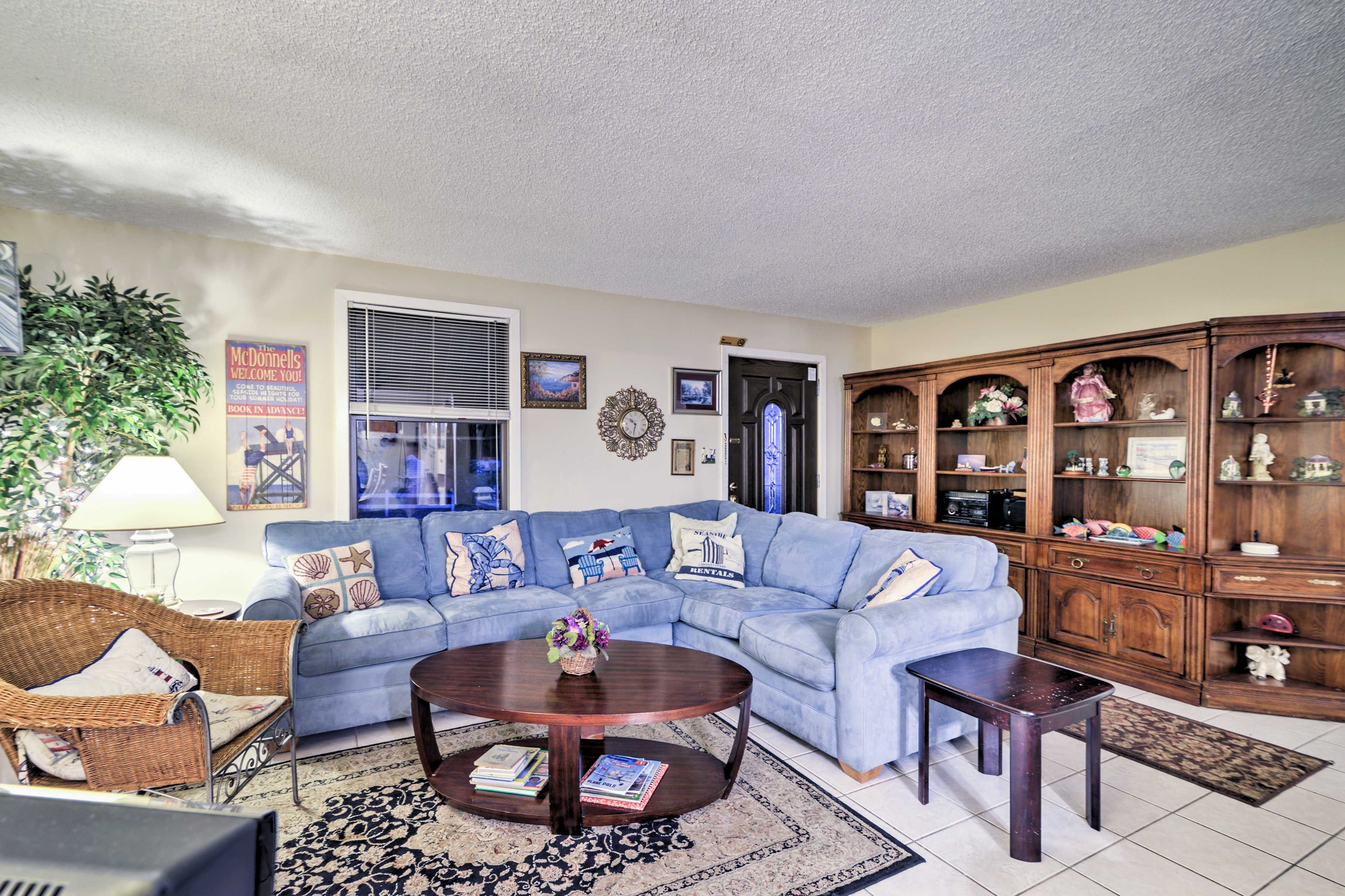 The living room features a comfortable plush sofa.