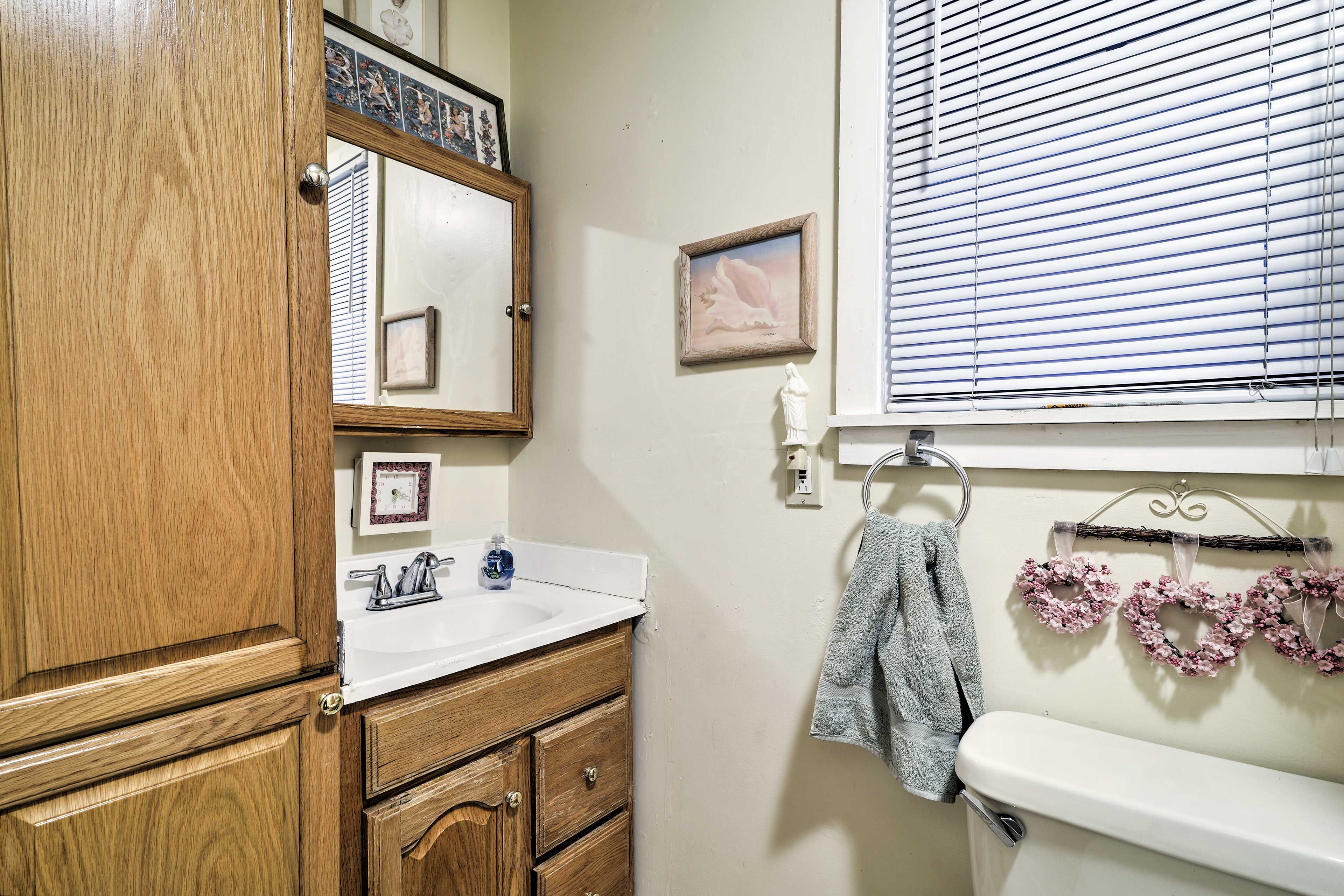 This home is equipped with a full bathroom, an outdoor shower and a half-bath.