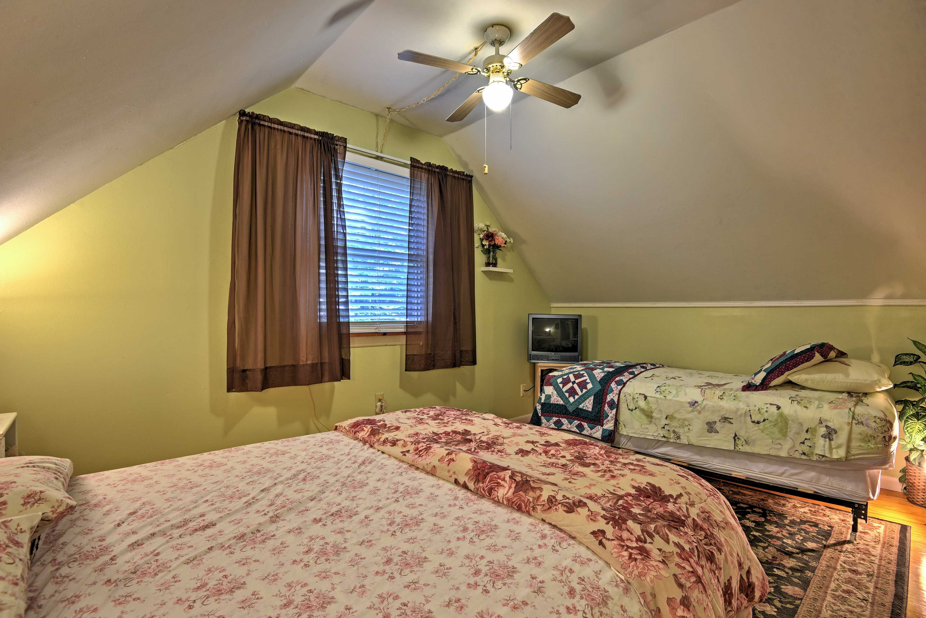 This bedroom offers a full-sized bed as a well as a twin bed for guests to sleep in.