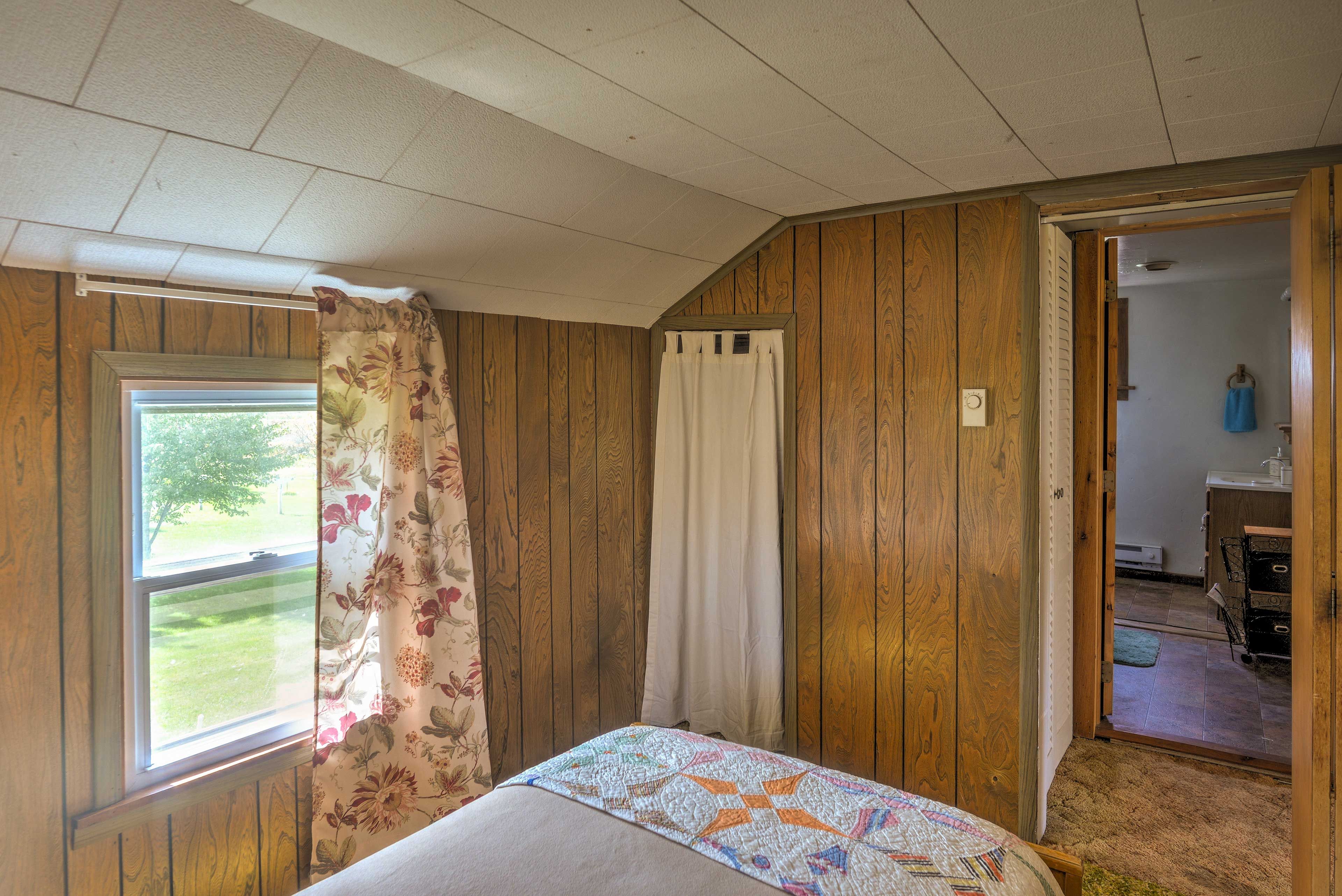 The rustic feel extends into the bedroom.