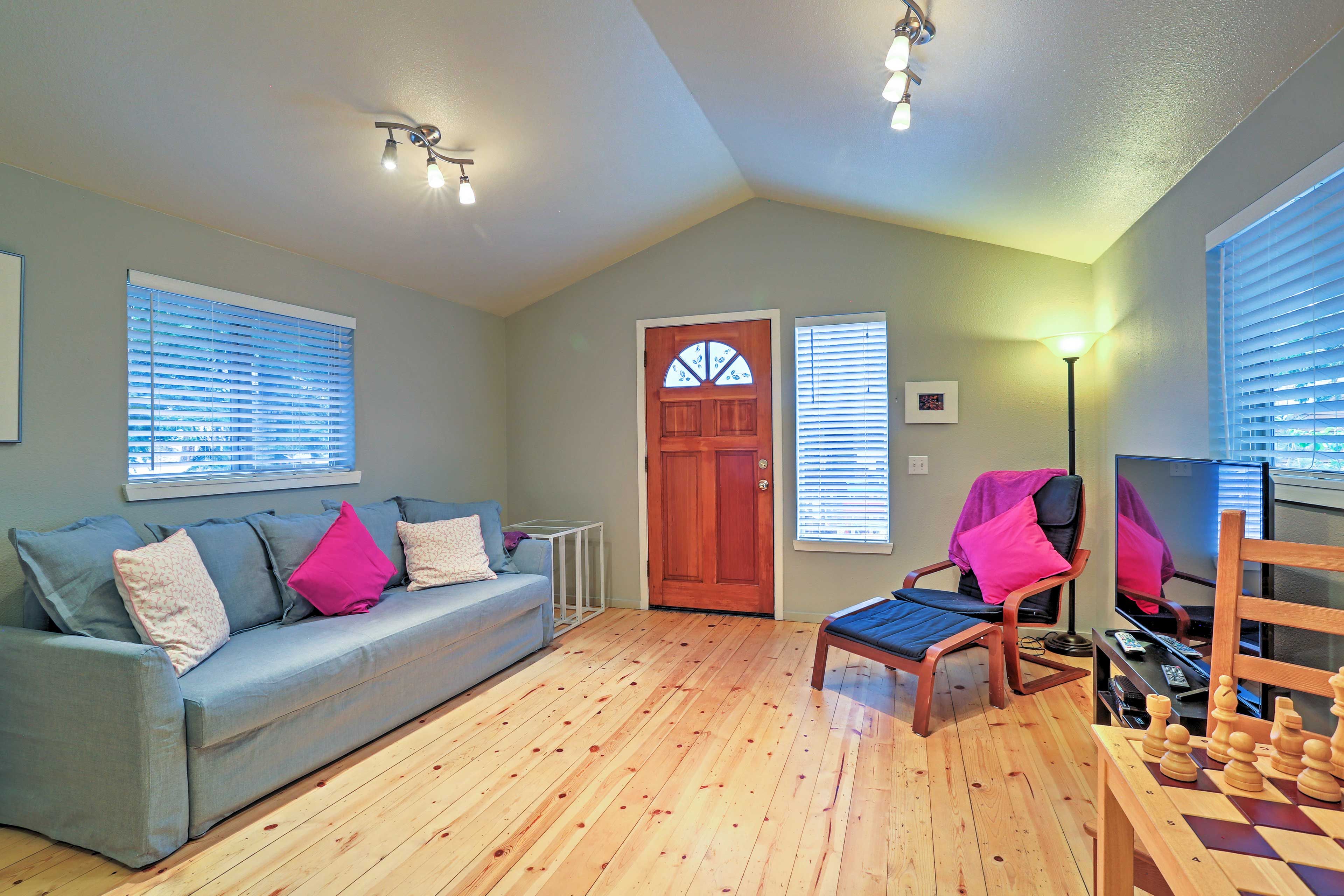 Stunning hardwood floors highlight the living room with cozy furnishings.