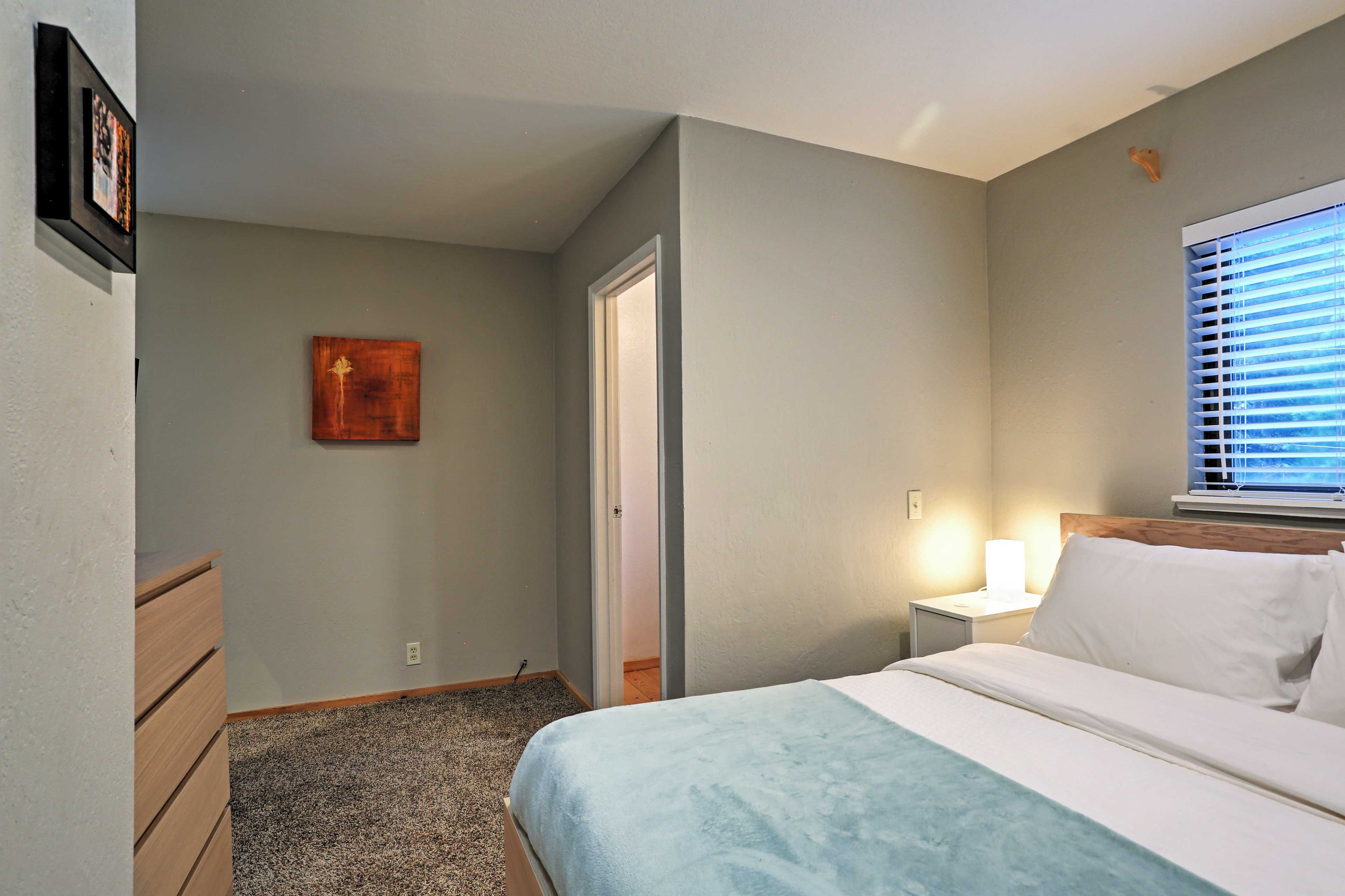 Rest your head on the soft queen-sized bed in the main bedroom.