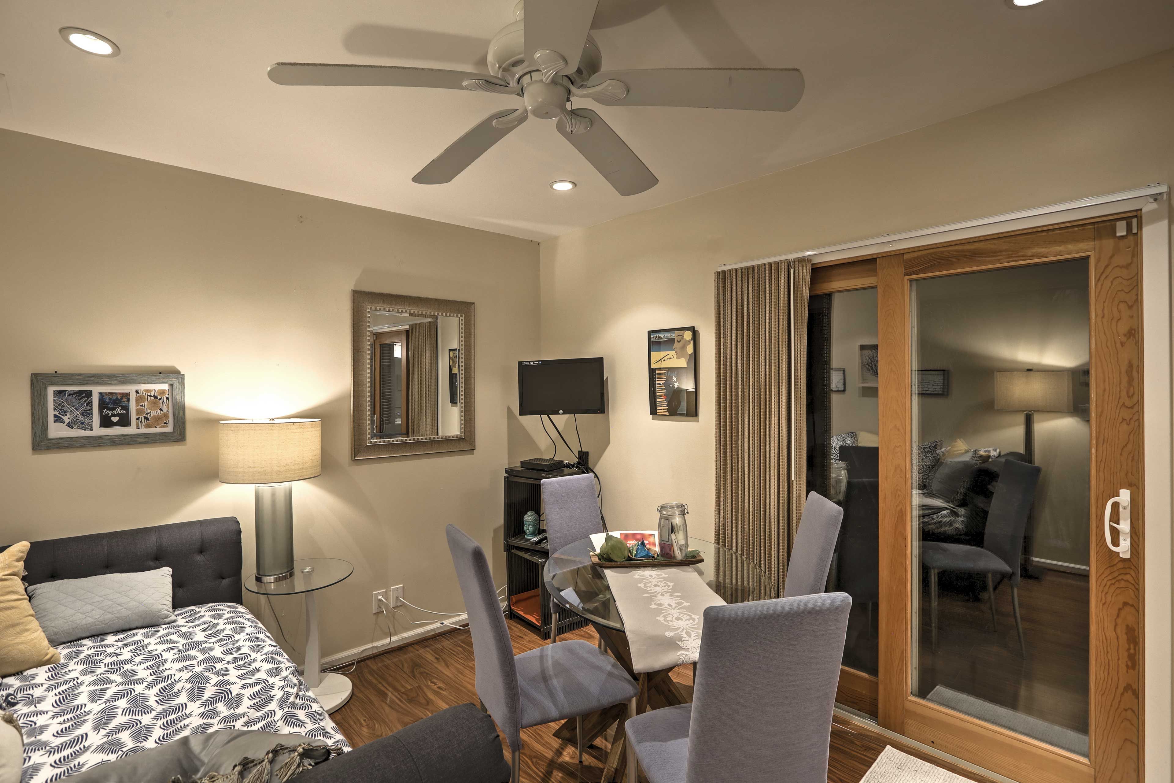 Open the sliding glass doors and enjoy the fresh air while eating at the dining table set for 4.