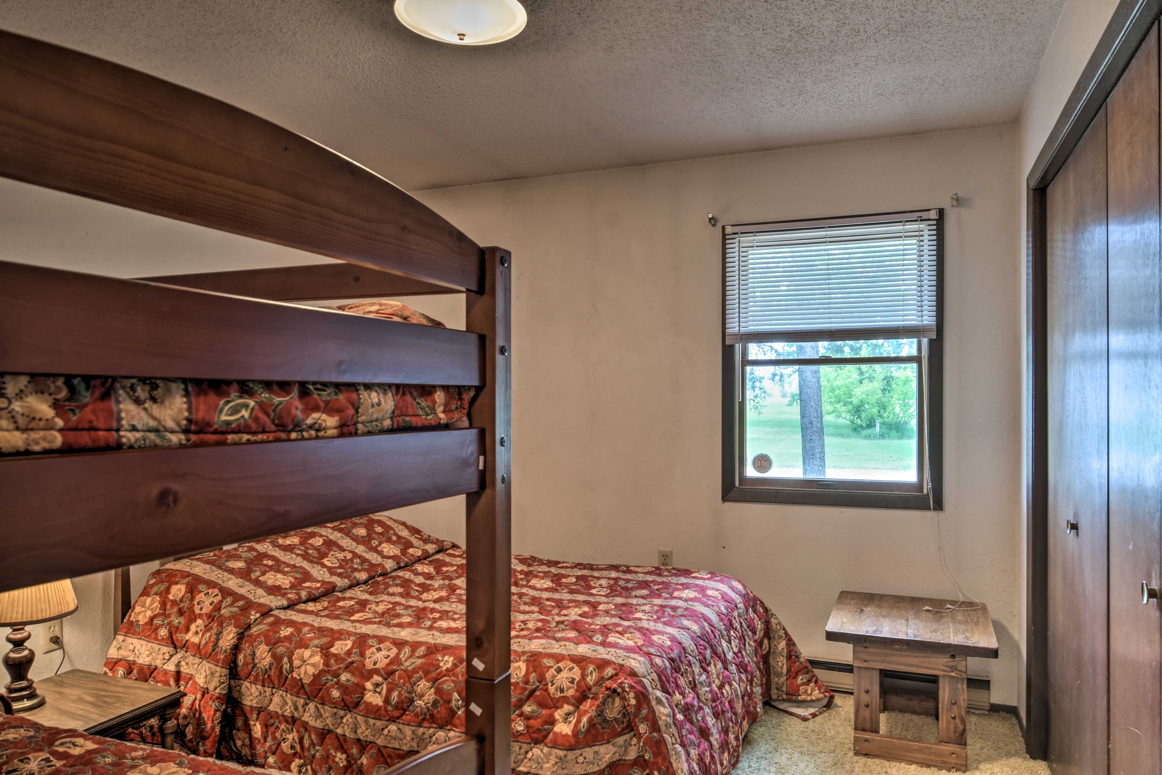 The bedroom includes a full bed and twin-over-twin bunk bed.