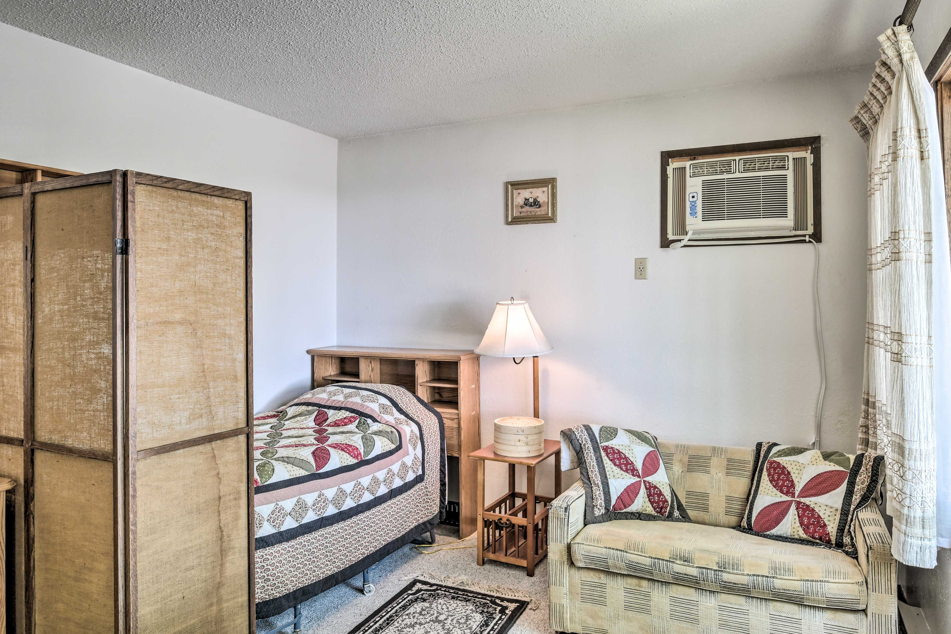 One guest can claim the twin bed with privacy screen at night.