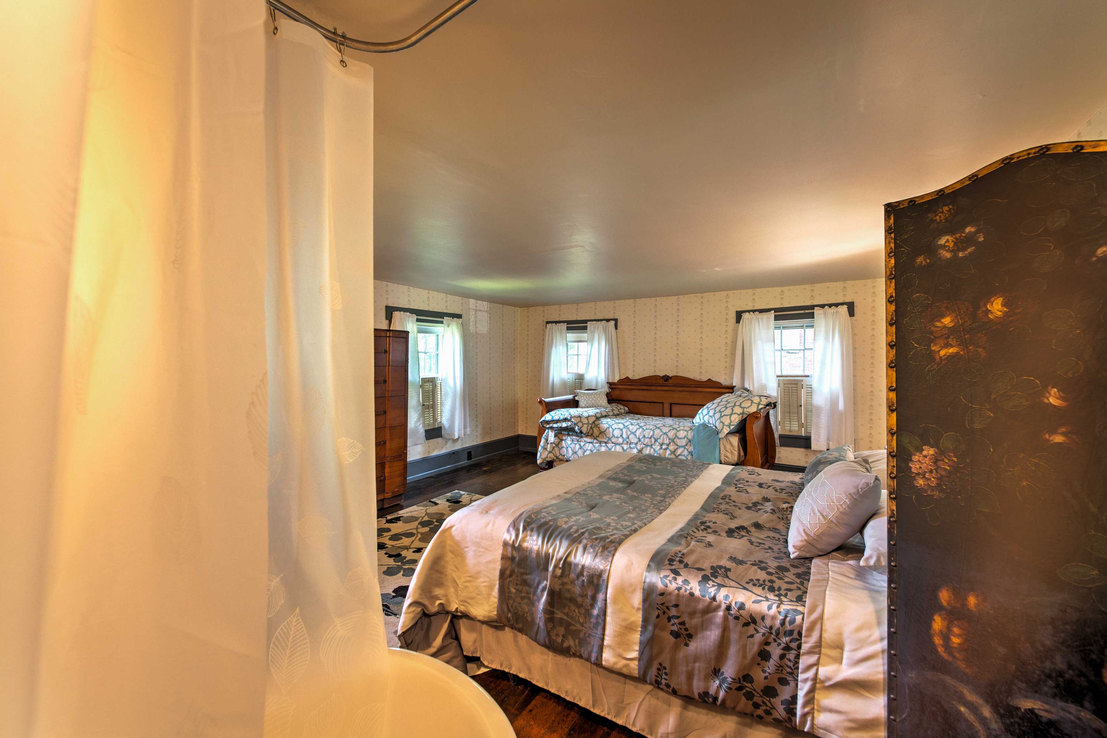 The bedroom features a clawfoot tub/shower combo and single vanity.