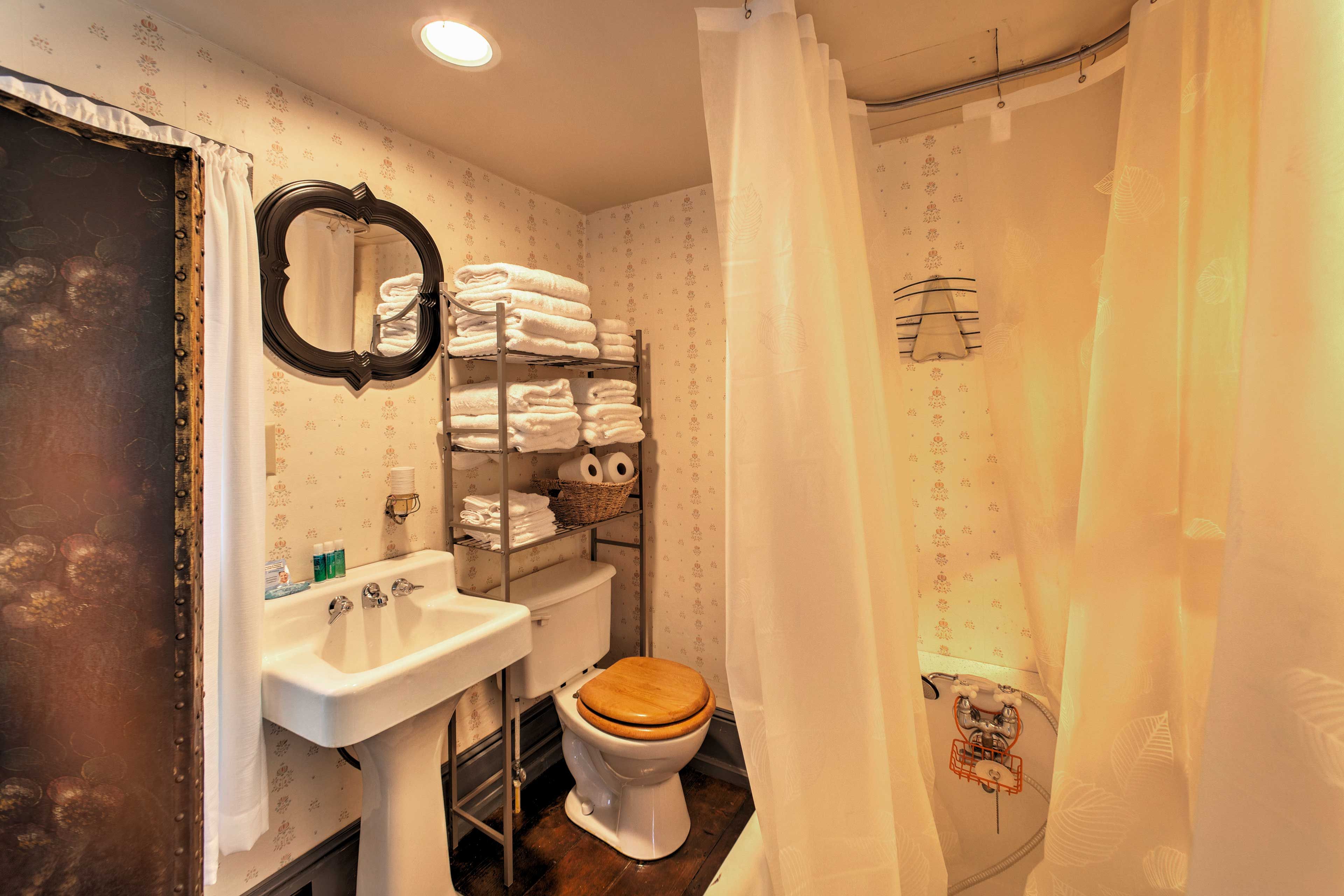 Please note the bathroom is not fully enclosed - only separated by a divider.
