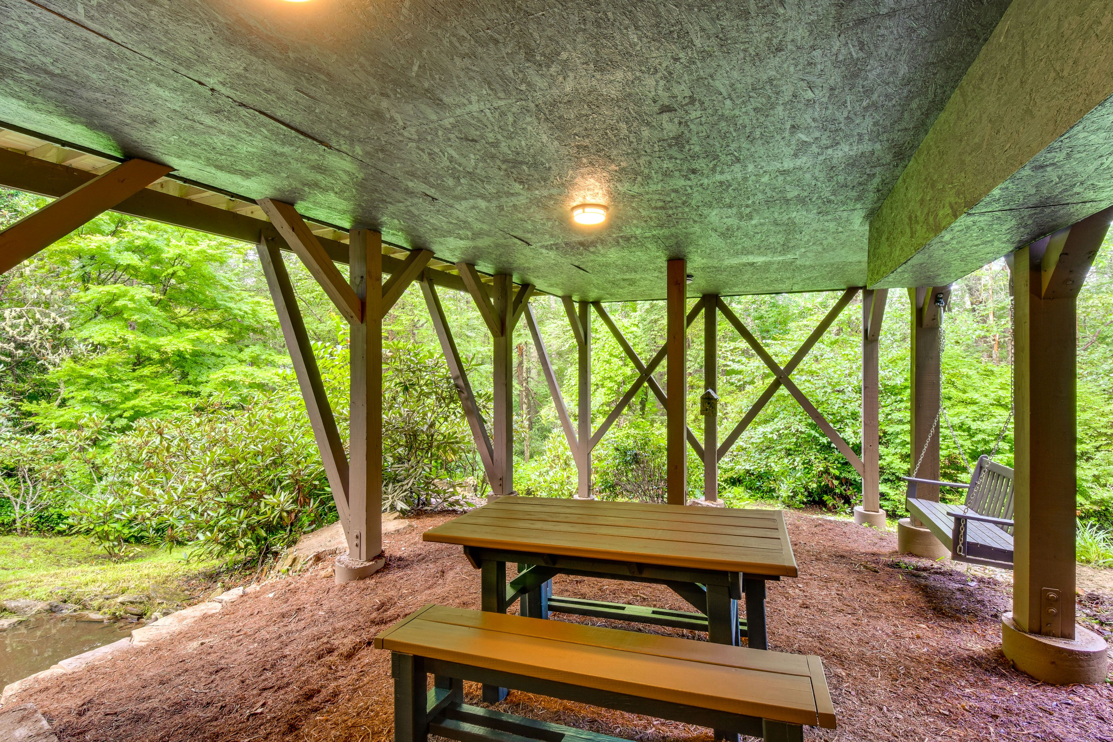Covered Patio | Outdoor Dining | Porch Swing | Pond & Waterfall Views