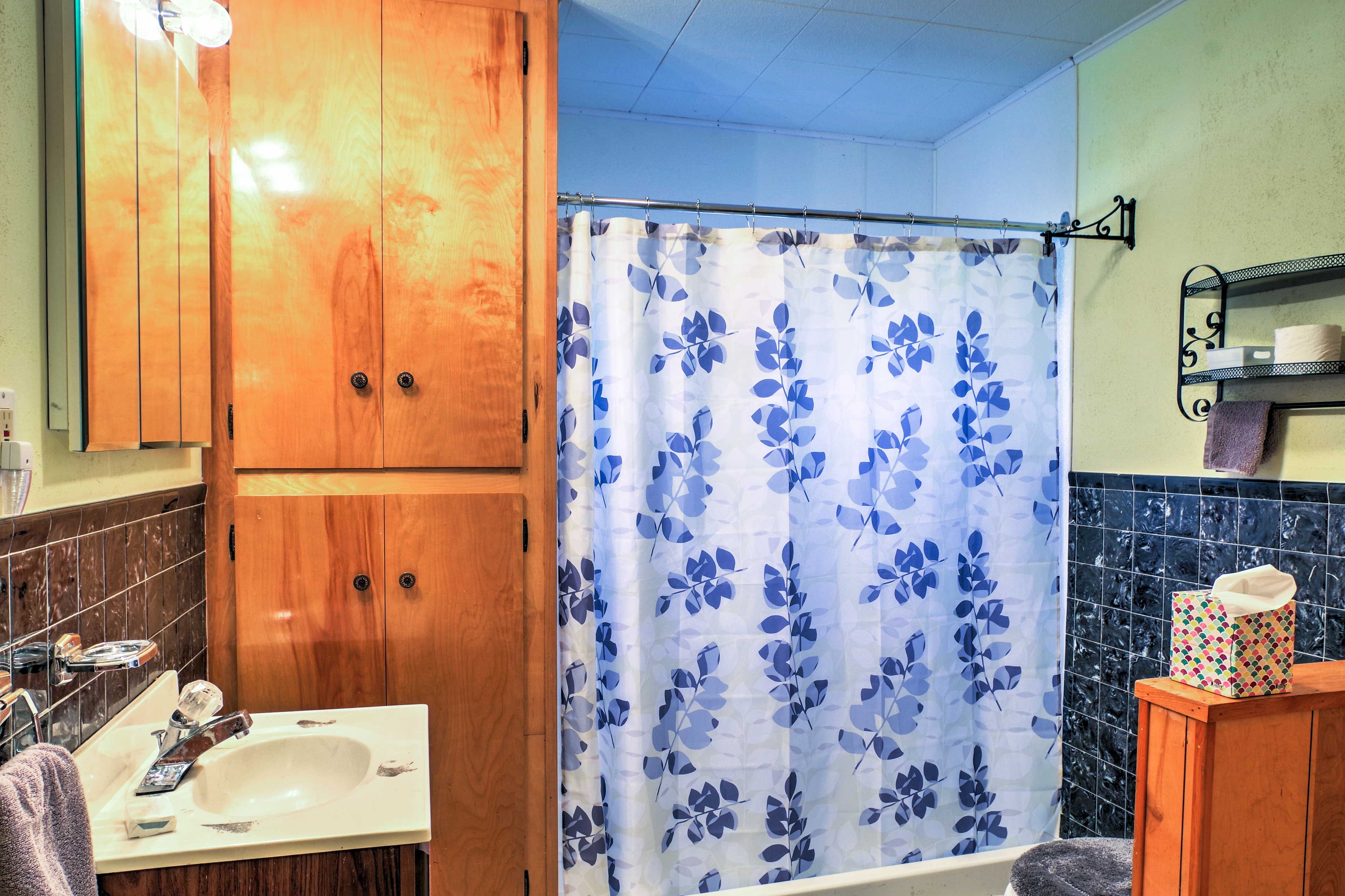 Freshen up in the fall bathroom that features a shower/tub combo.