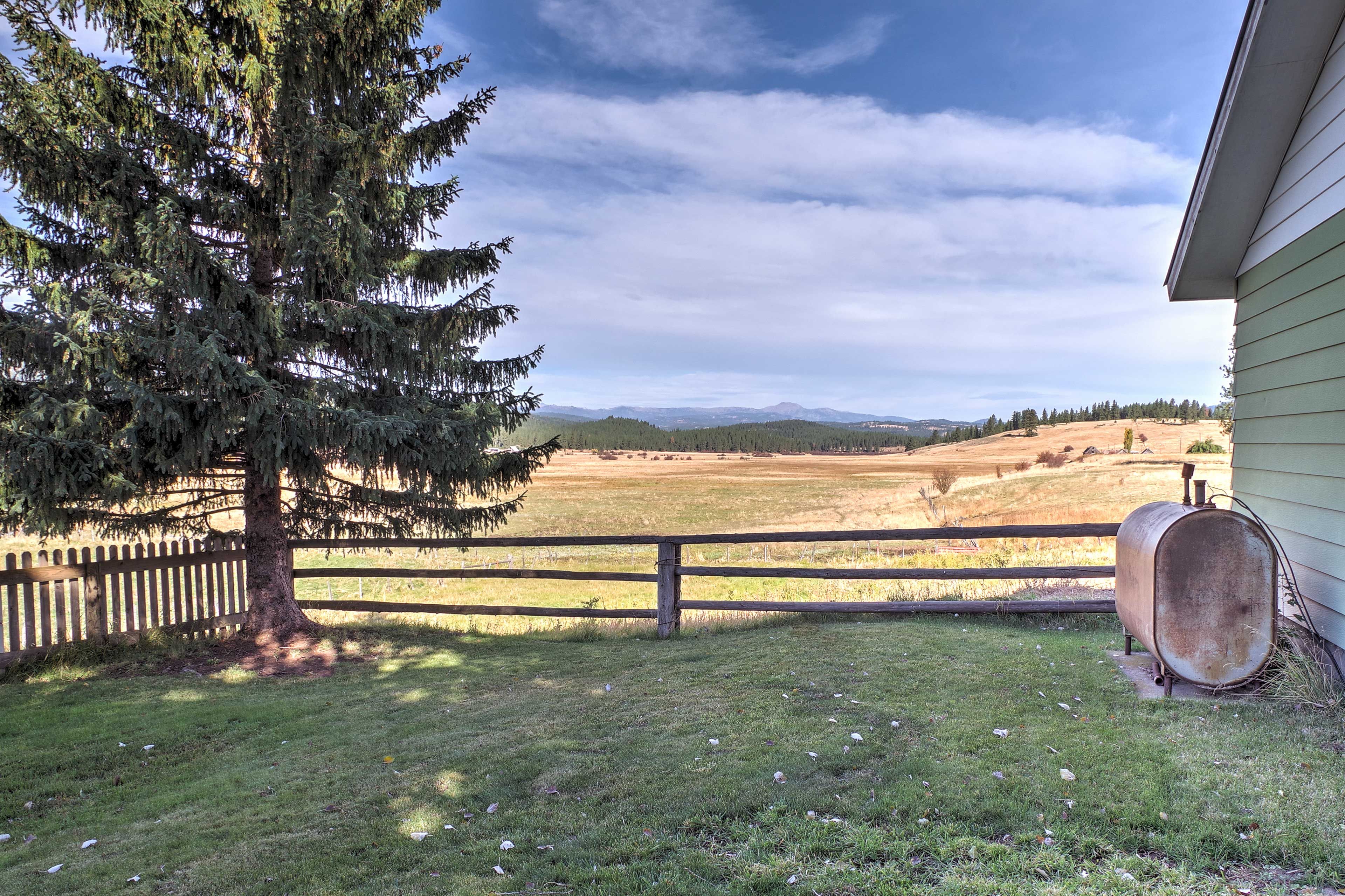 Stroll around this dreamy property and admire the evergreen trees, wildlife, and the vistas of the mountain ranges.